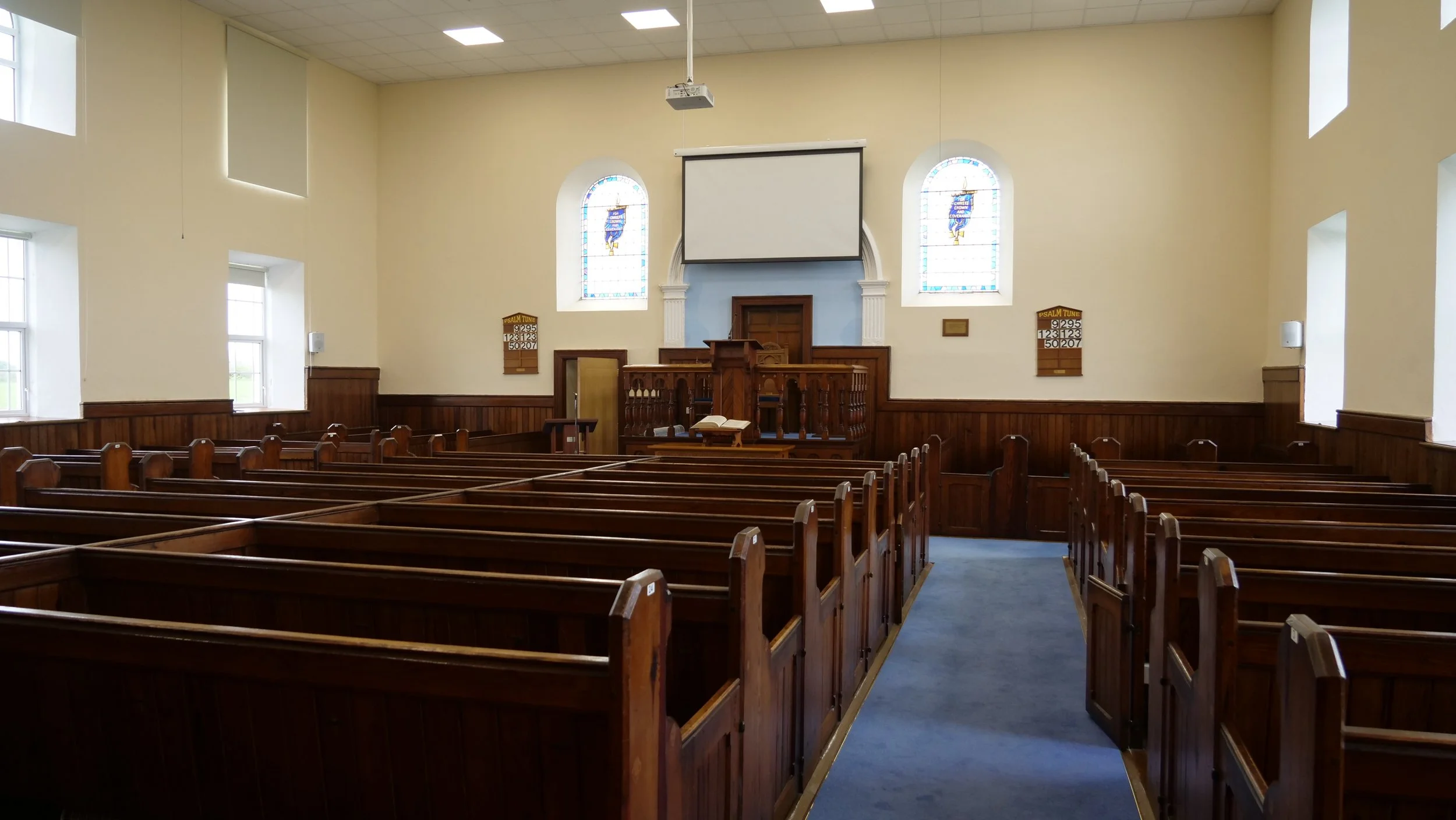 Inside Ballylaggan Reformed Presbyterian Church, rows of wooden pews facing the front