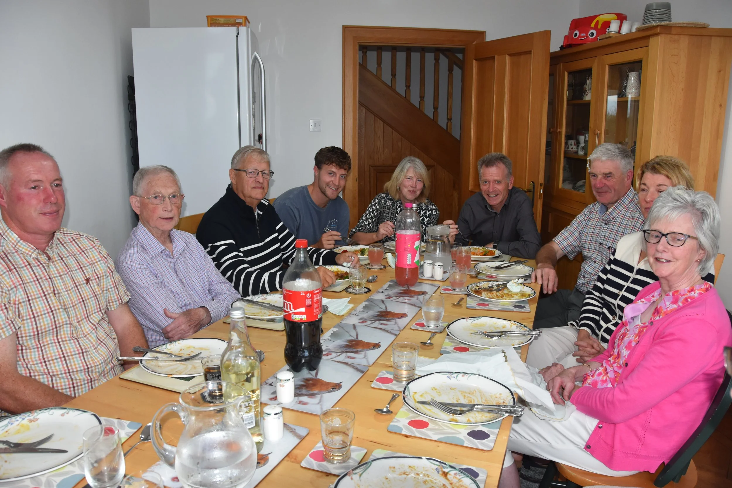 Ballylaggan RPC members sharing a meal around a long table
