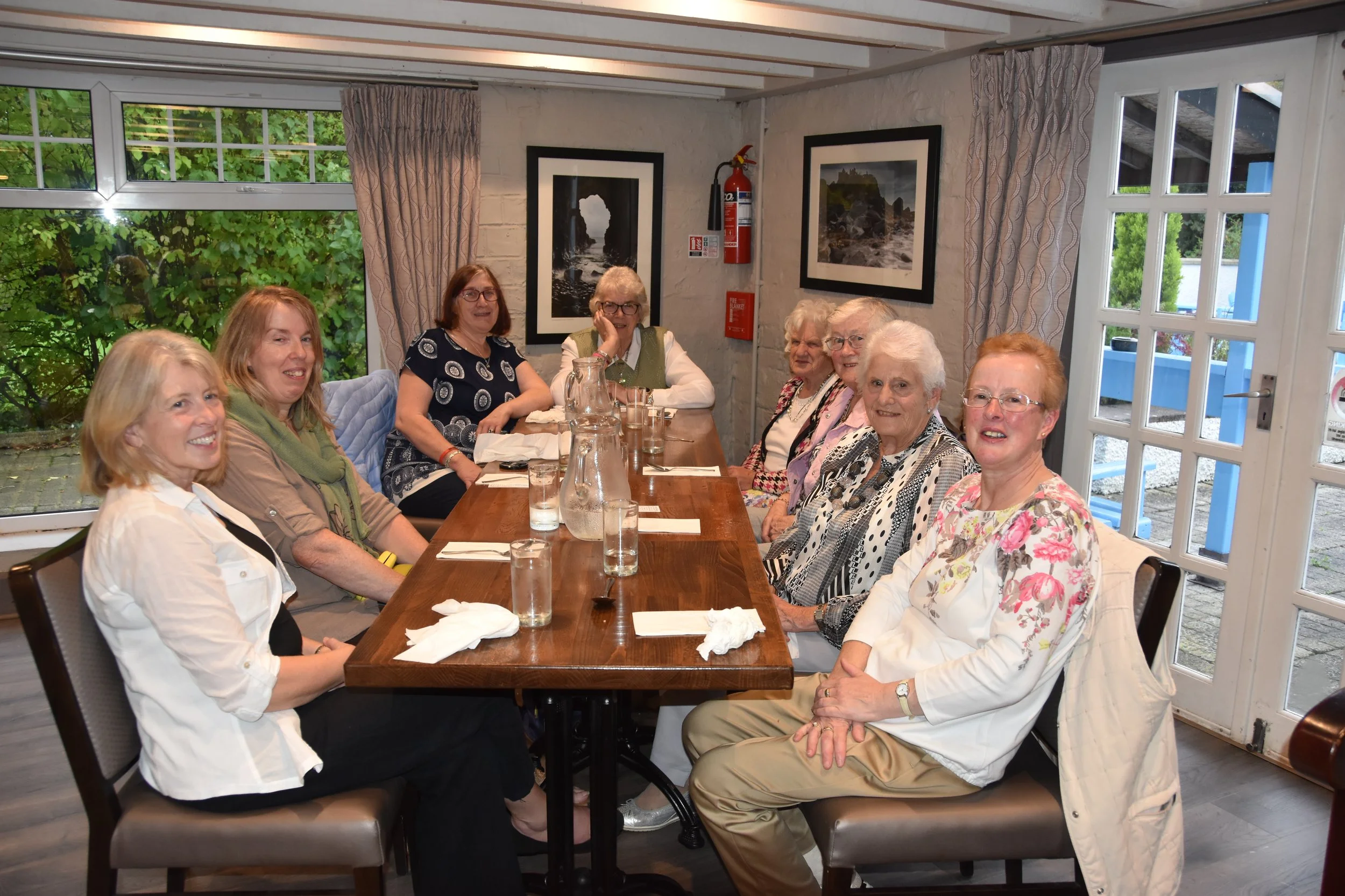 Women from the congregation gathered around a table for a fellowship meal