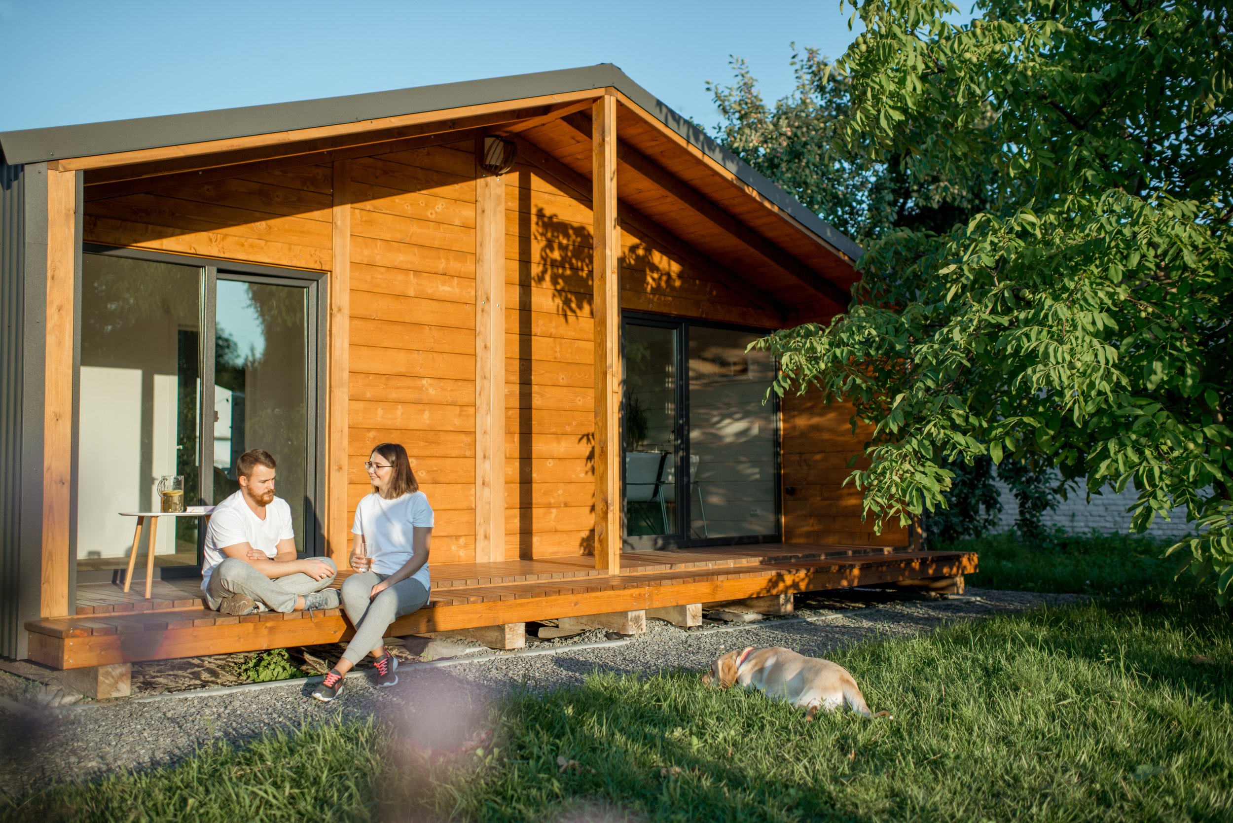 couple-with-dog-on-the-backyard-of-their-house-2023-11-27-05-15-12-utc.jpg