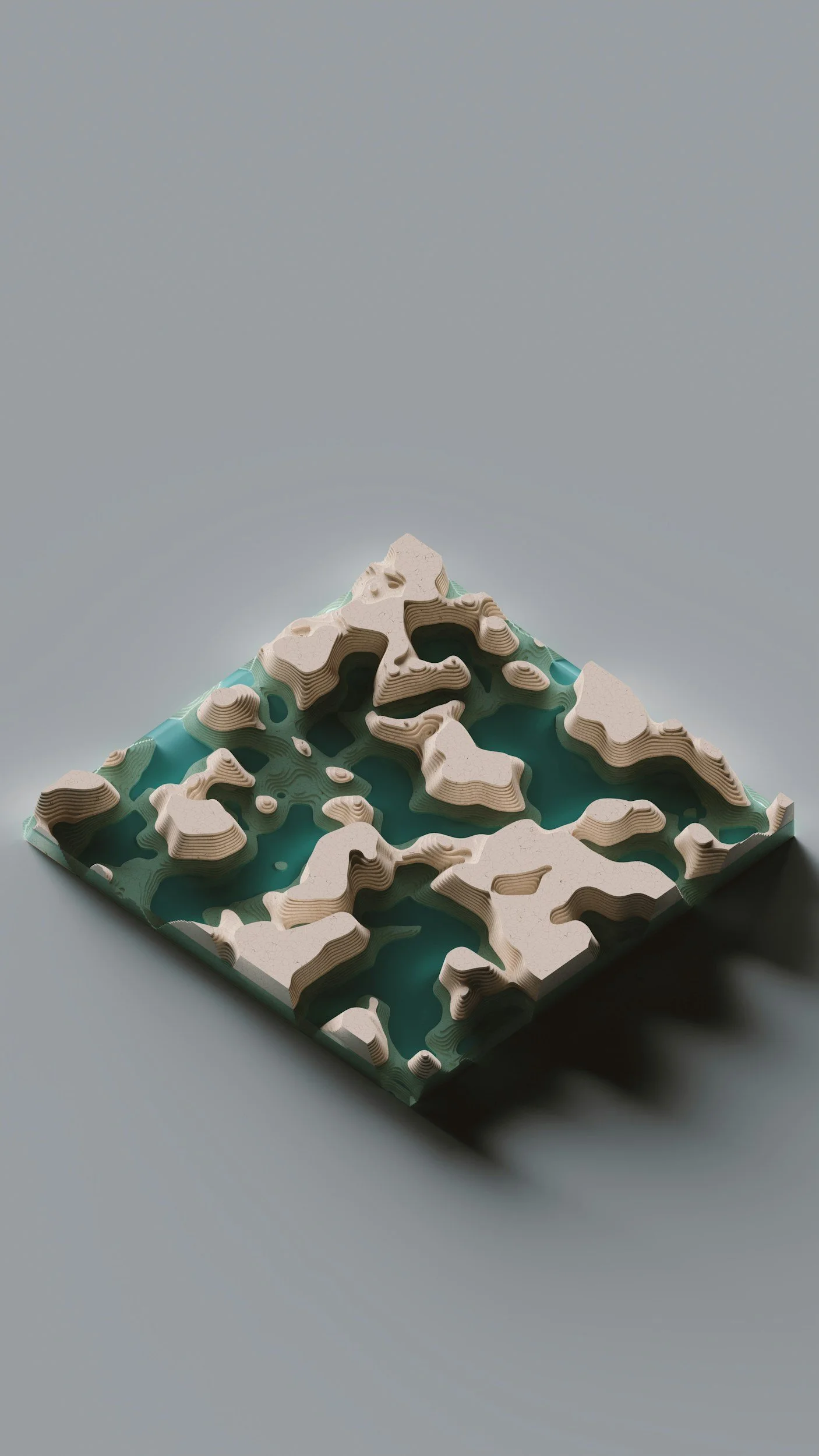 A topographical map model with beige terrain and teal water features, placed on a light grey surface.