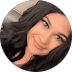 A woman with long dark hair smiling.
