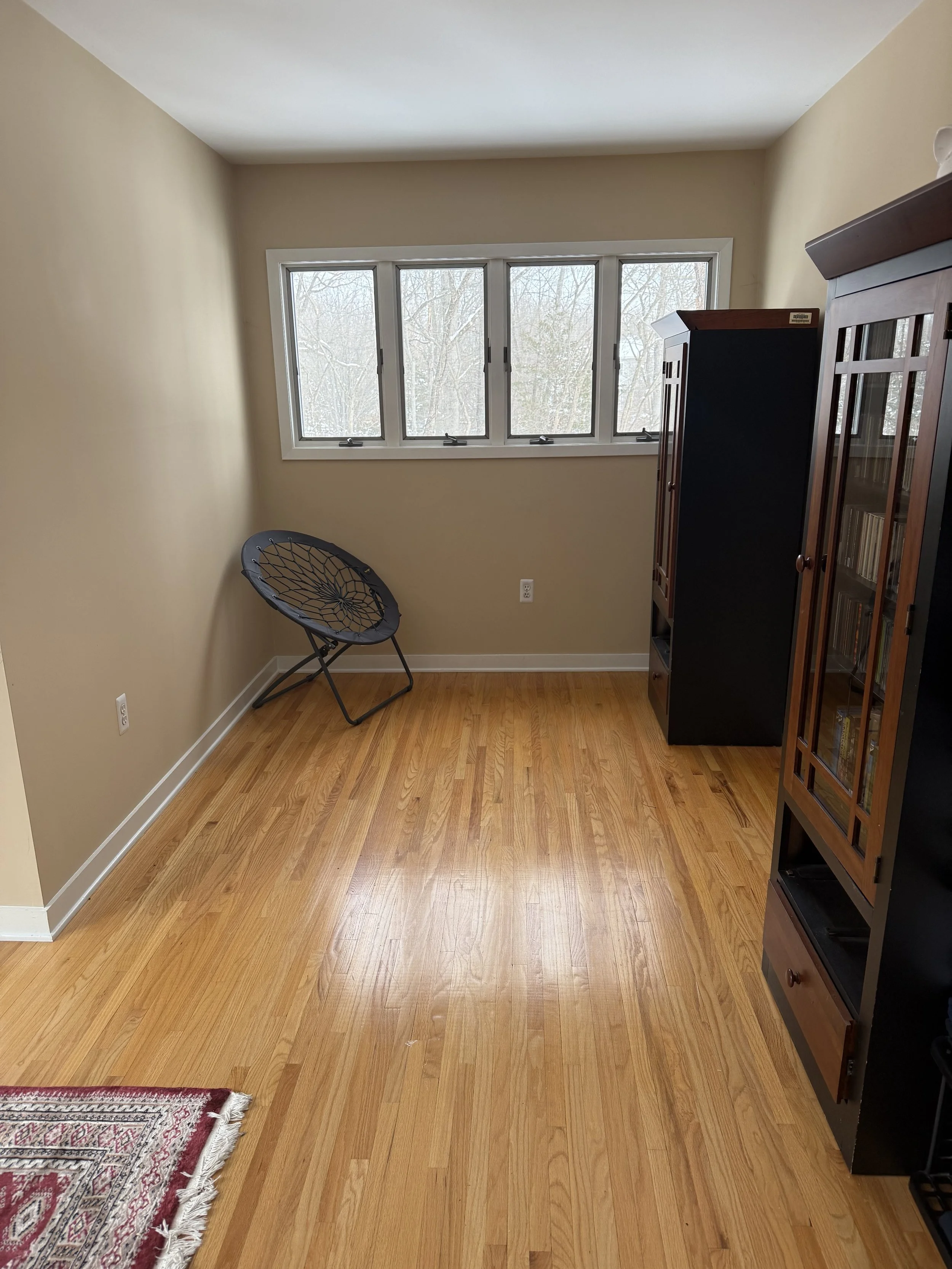 Cleared and organized spare room after professional organizing in Mercer County, Central New Jersey, with open floor space and minimal furnishings.