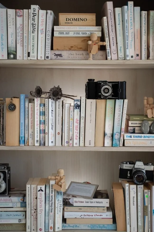Organized bookshelf with books and decor in a West Windsor, New Jersey home