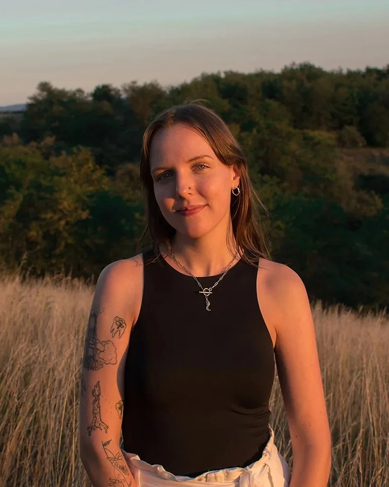 Cassidy Flynn, MA, a warm and approachable therapist, smiling in a natural light headshot.