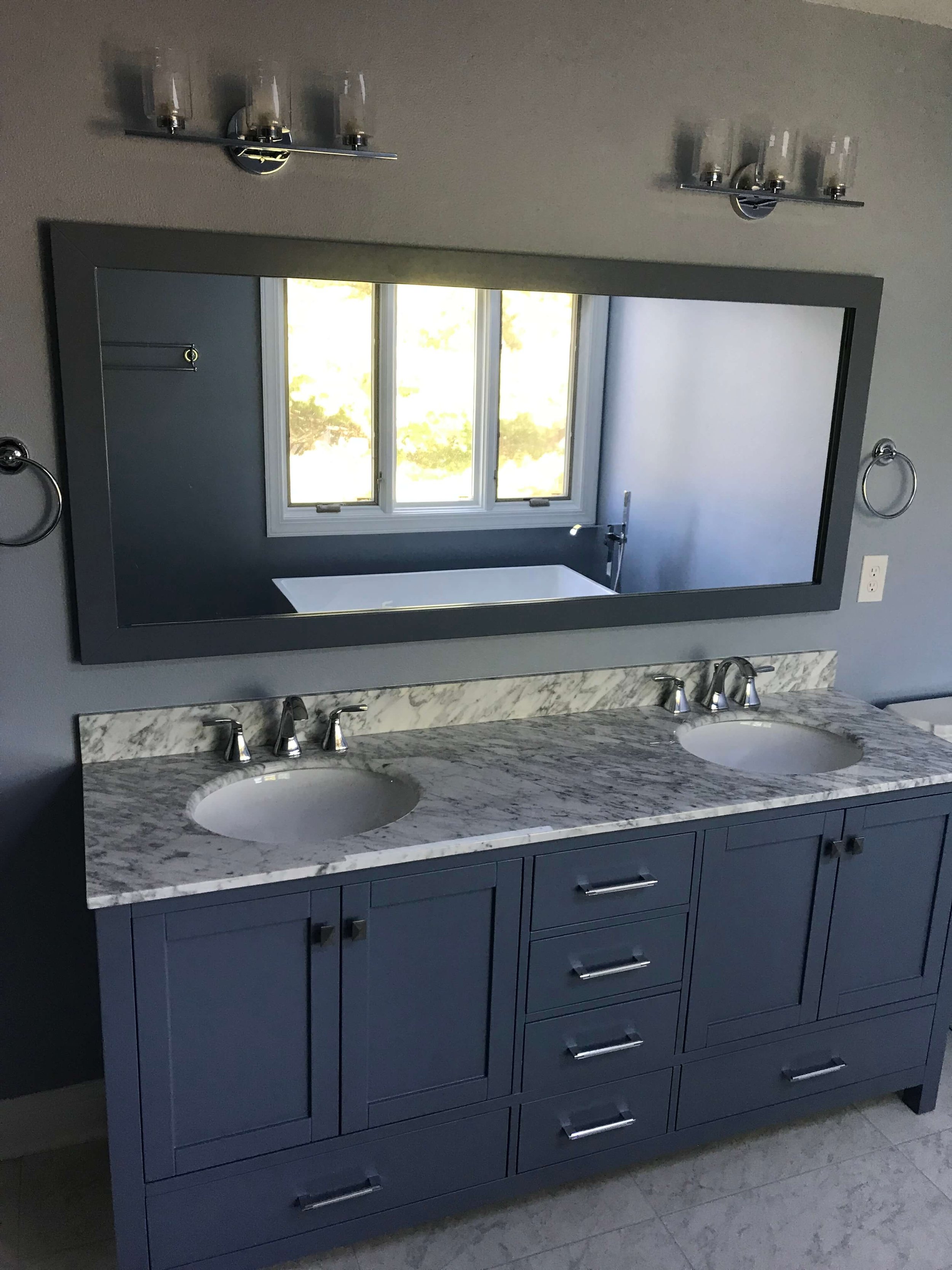 Professional tub-to-shower conversion in a Des Moines bathroom featuring a curbless entry tile shower and modern matte black hardware.