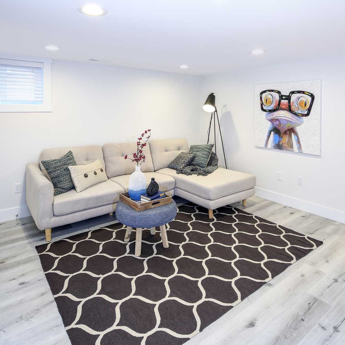 Organic modern basement bathroom with herringbone wood feature wall and live-edge vanity.