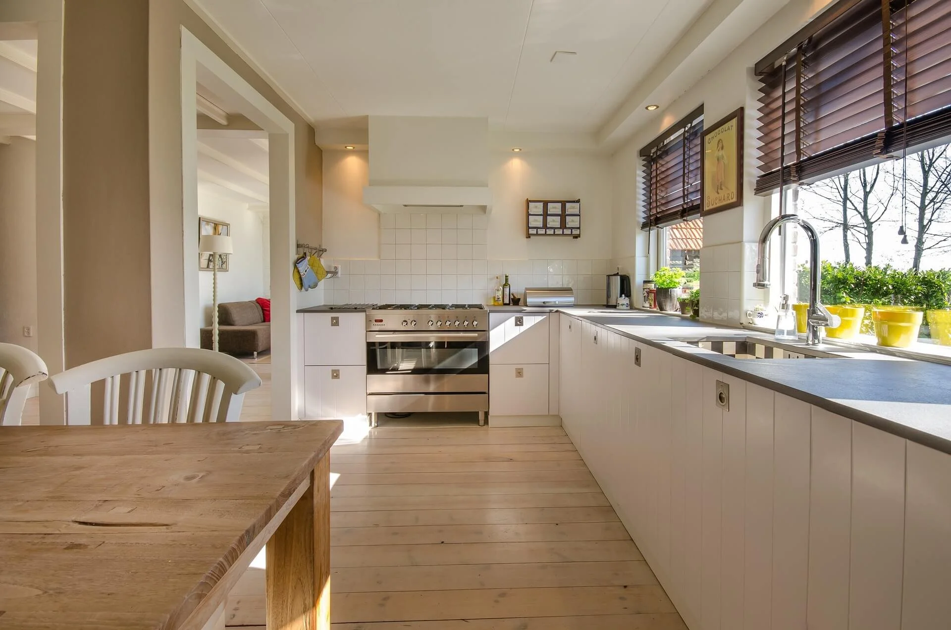 Bright modern kitchen remodel with white cabinets, open layout, and natural light in a residential home