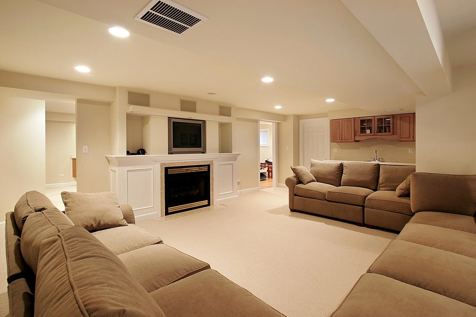 Finished basement living room with fireplace, entertainment center, recessed lighting, and comfortable seating in an Urbandale home