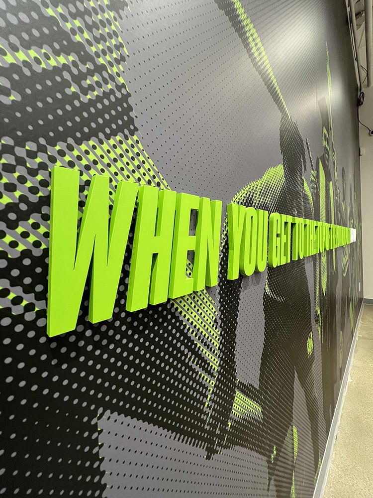 Bright green 3D text on a black dotted background spelling out "WHEN YOU GET THE CHANCE" with a half-gloved hand holding a spray paint can.