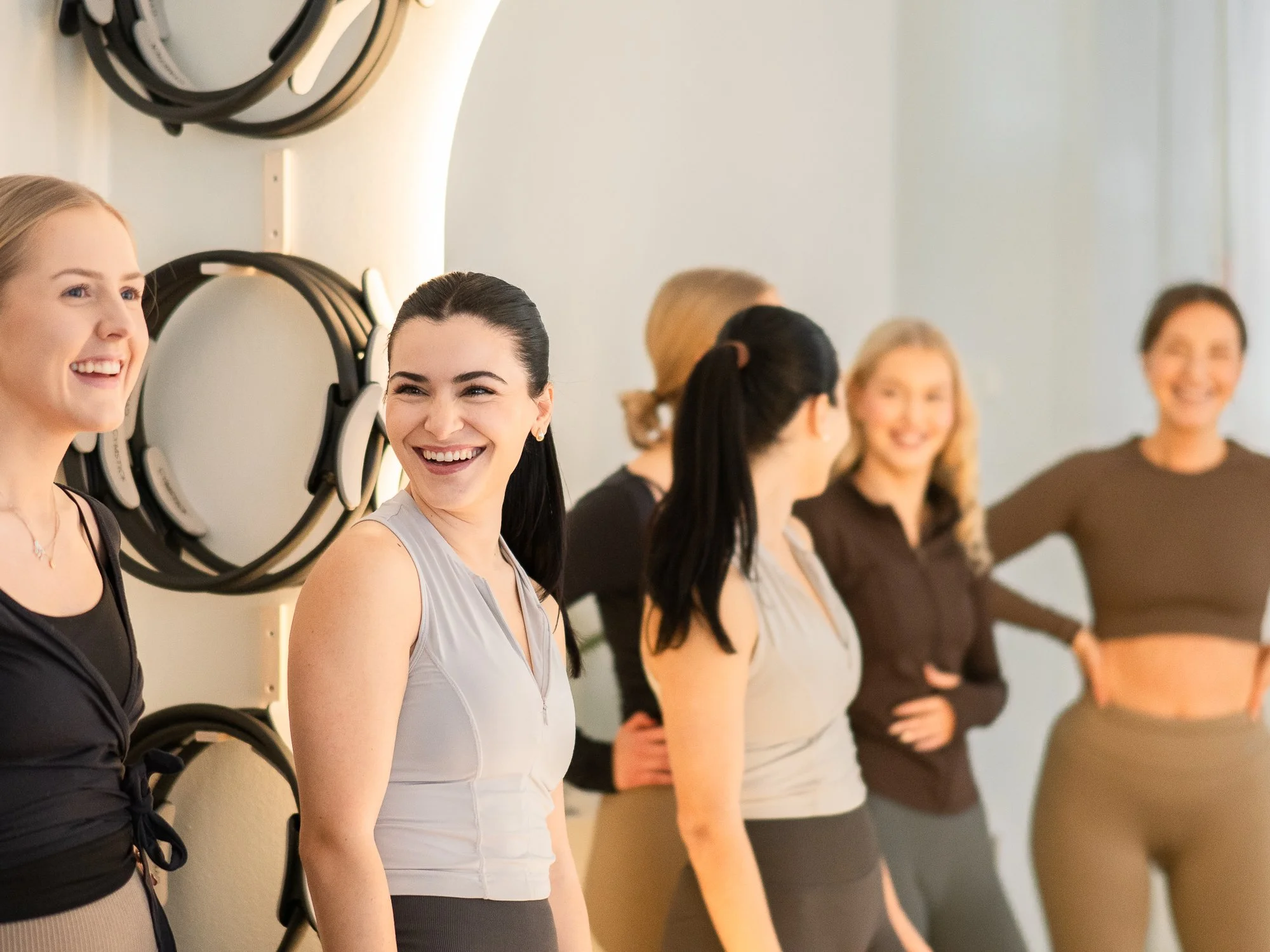 Woman in pilates studio Helsinki ready to do pilates in helsinki. Aesthetic studio and happy woman practicing pilates.