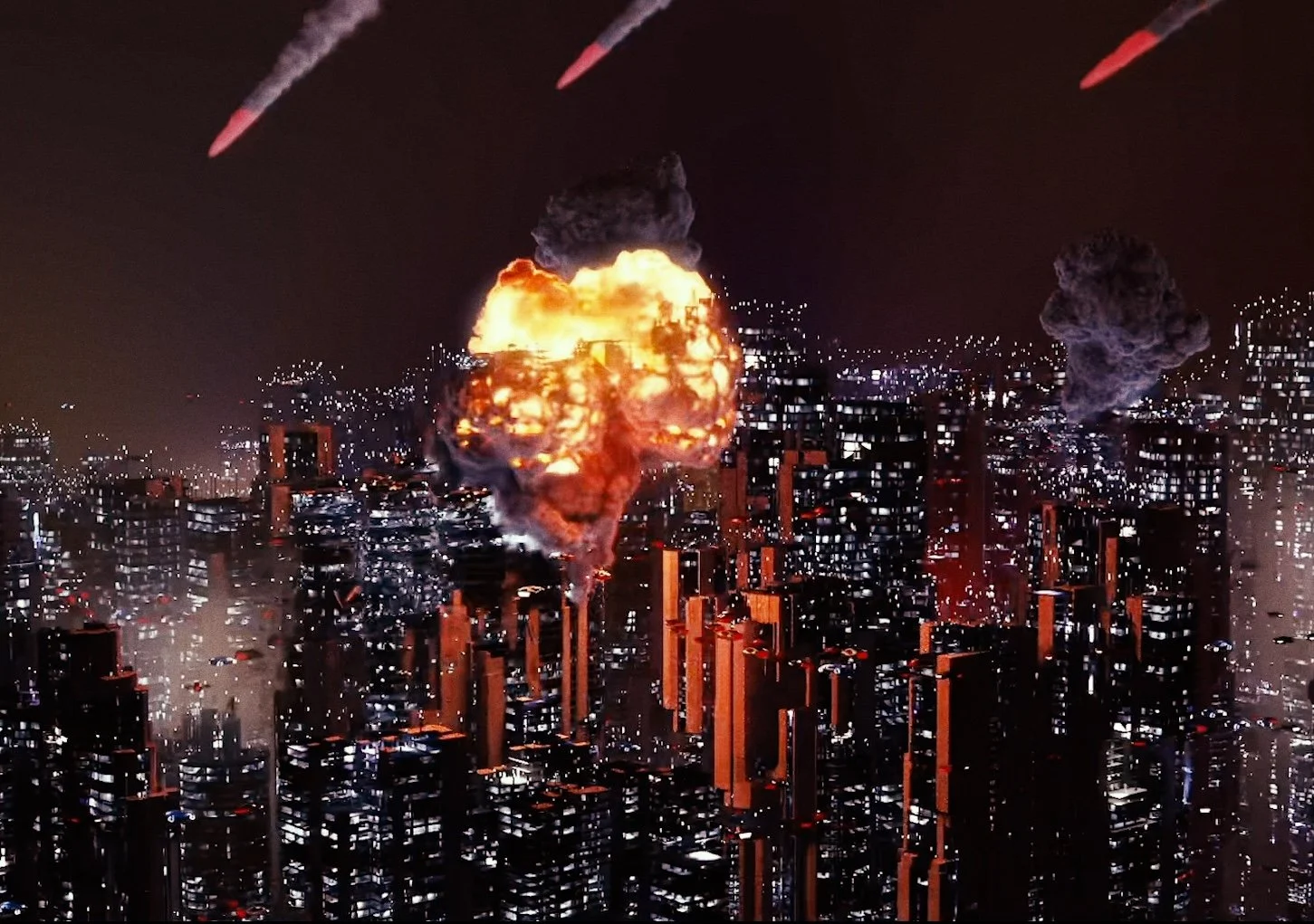 City skyline at night with multiple buildings, some on fire with large explosions and billowing smoke, and missiles falling from the sky.