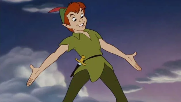 Cartoon character Peter Pan flying against a cloudy night sky.