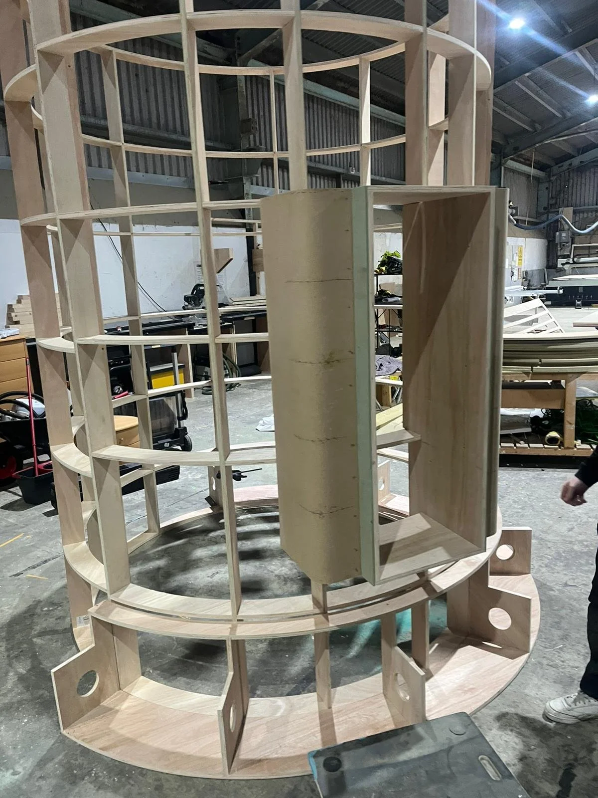 THE BUZZBALLZ gatcha  with multiple curved and straight sections, construction in progress inside a workshop.