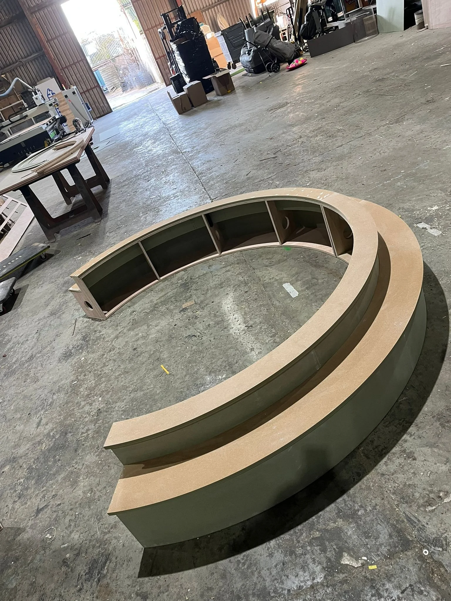 steps of THE BUZZBALLZ gatcha  in a workshop with various tools and equipment in the background.