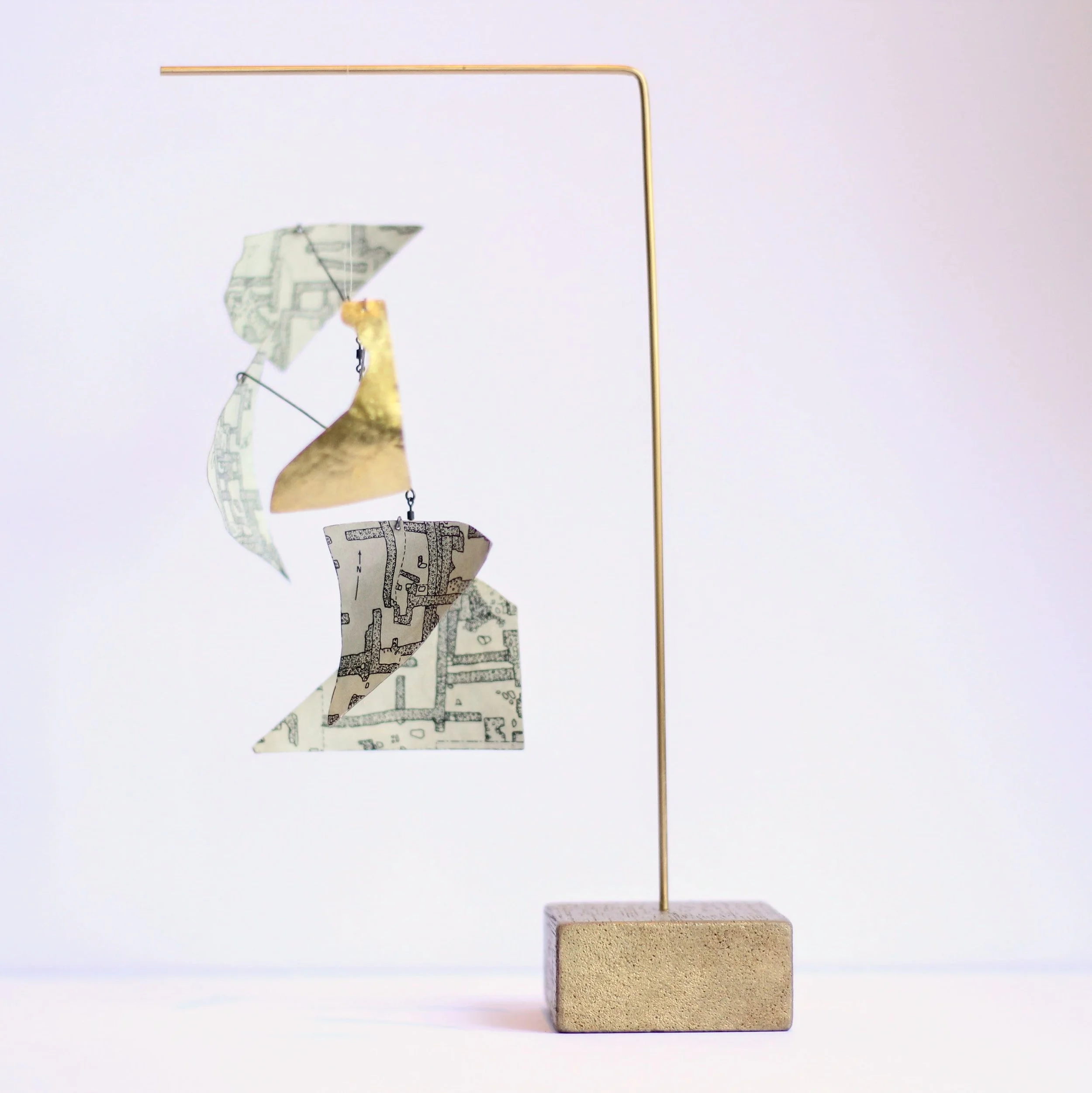 Strange Receiver #5 brass, fishing swivels, vintage wooden toy building block, collaged with a map of stone settlements from a vintage Atlas of Ancient Archaeology.