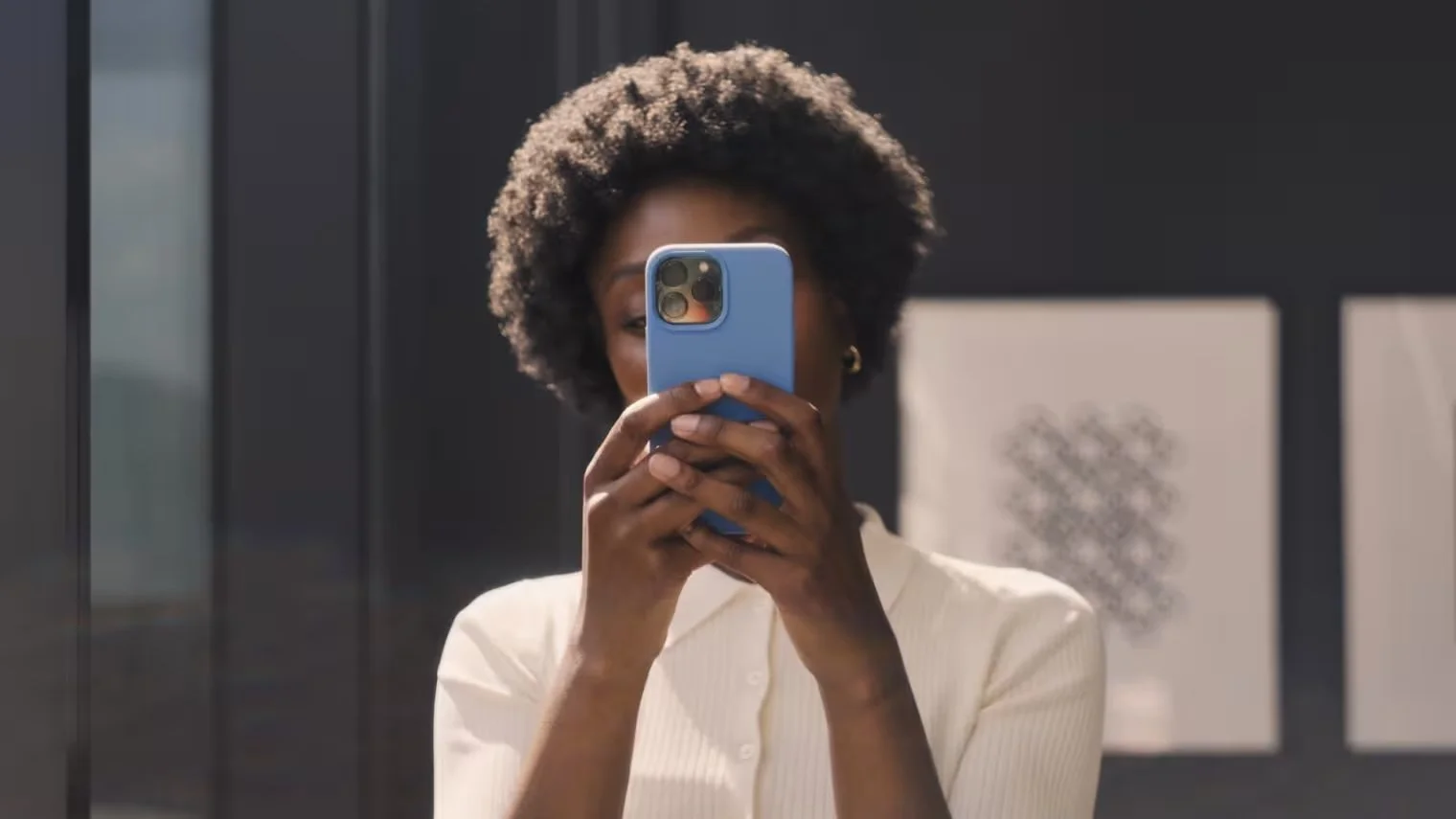 woman holding phone sending a text message