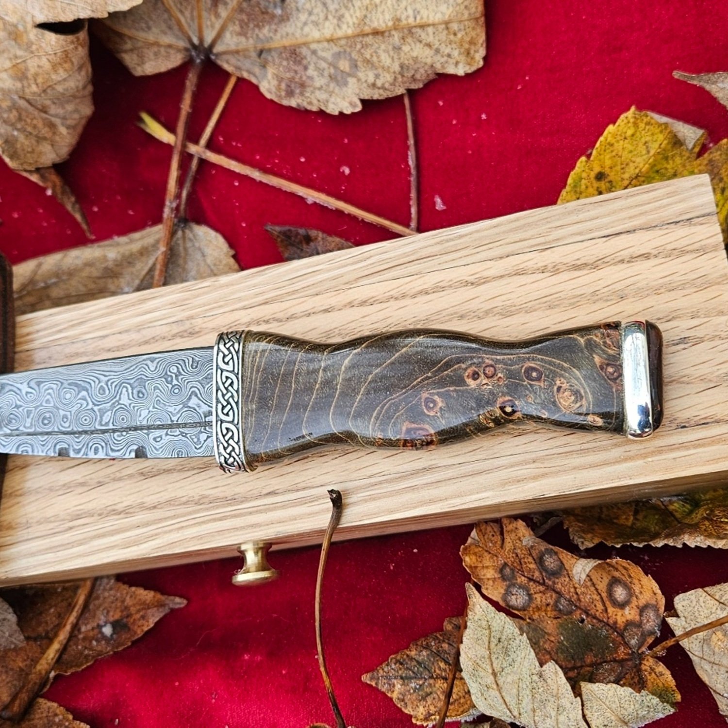 Black with natural features highlighted , spalted Maple wood with silver fittings
