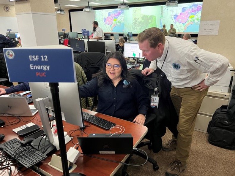 Former Public Utility Commission of Texas Chairman Peter Lake discusses storm preparations with staff at the Texas State Operations Center in Austin, Texas.