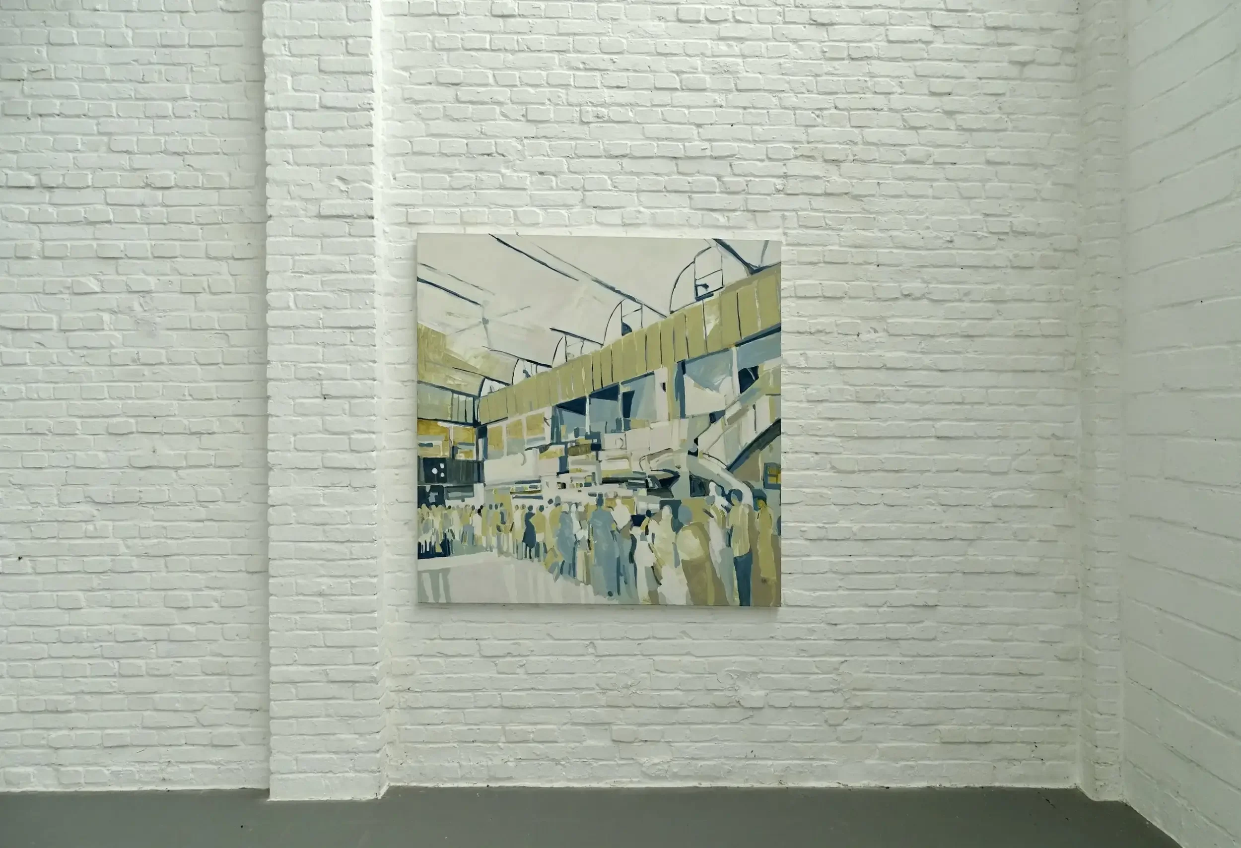 A painting hanging on a white brick wall, depicting a busy airport scene with a crowd of people and yellow structures.