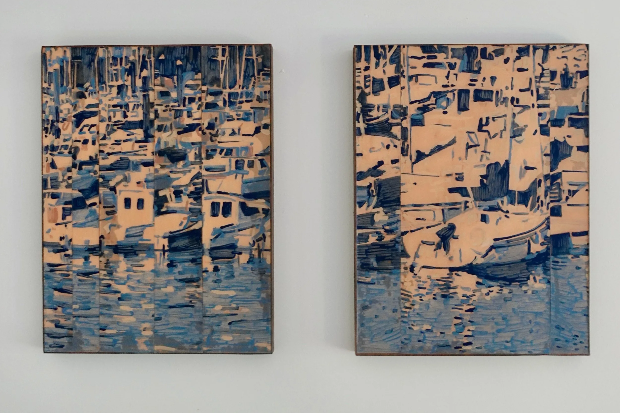Two collages of paintings of boats on the water, with blue and beige brushstrokes, hung side by side on a white wall.