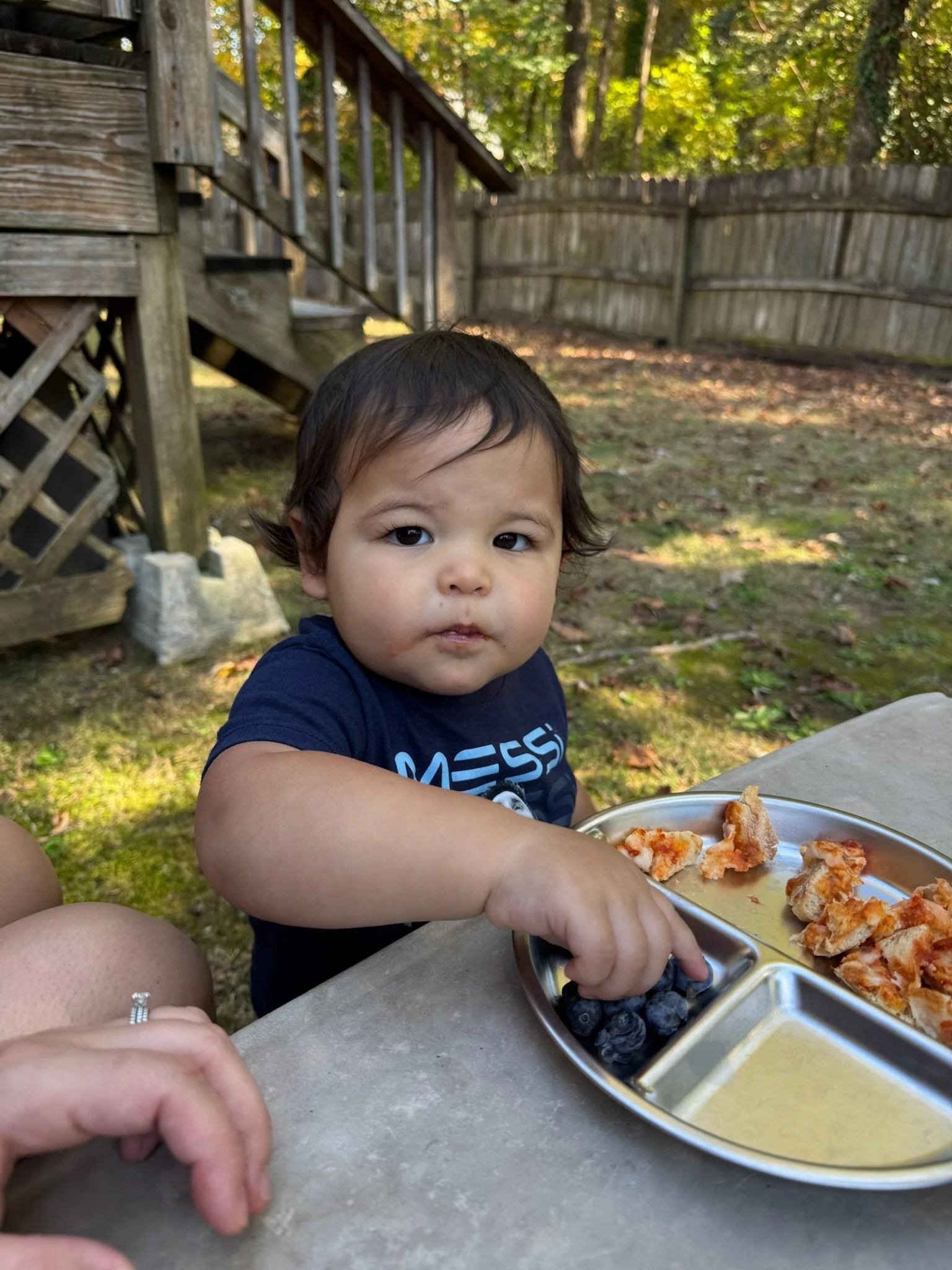 Kanoa eating outside with Mama
