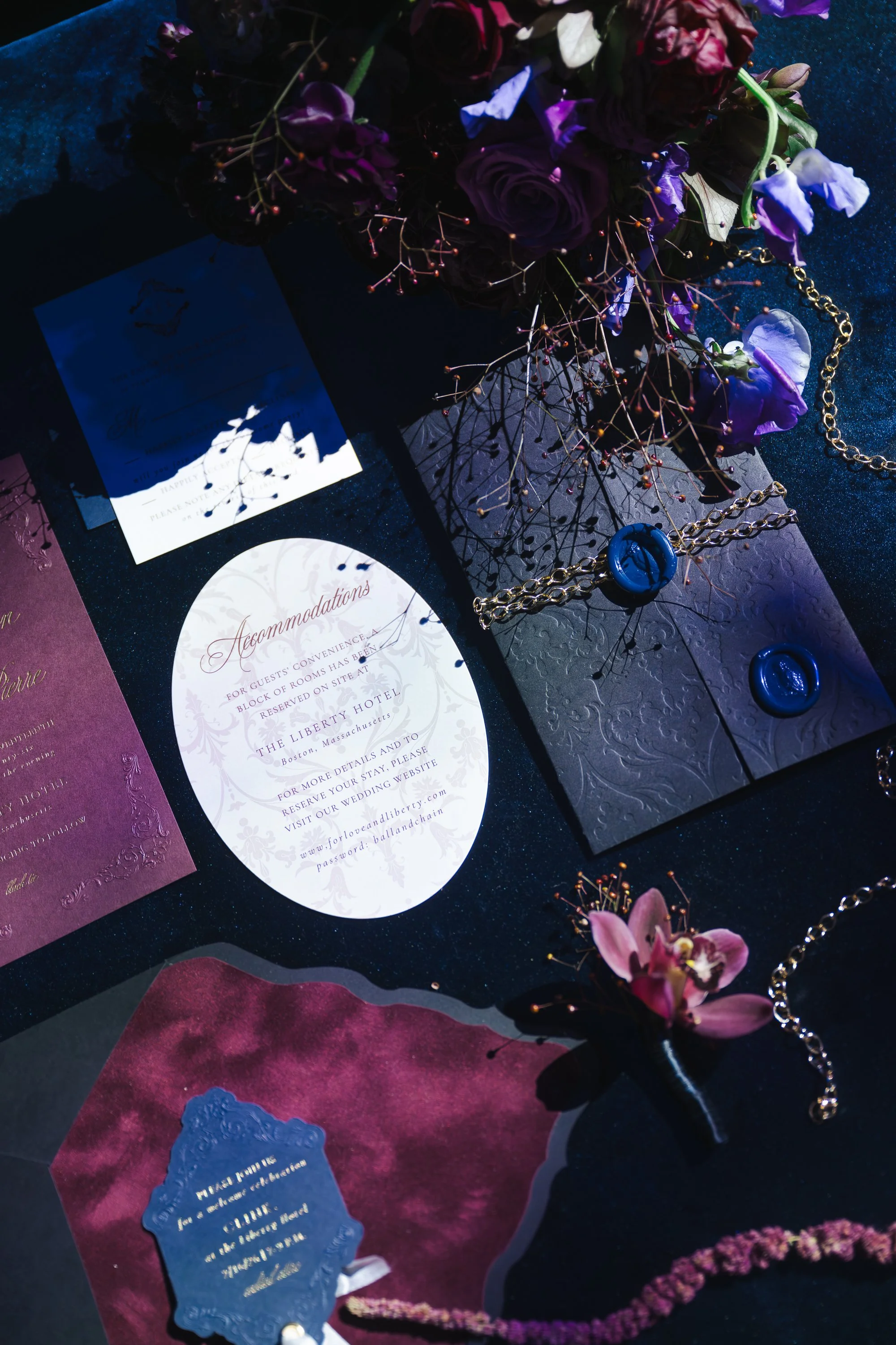 A large yellow house with a porch on a lawn with several people gathered, some standing and some seated, with a tent set up nearby for an outdoor event, and trees in the background.