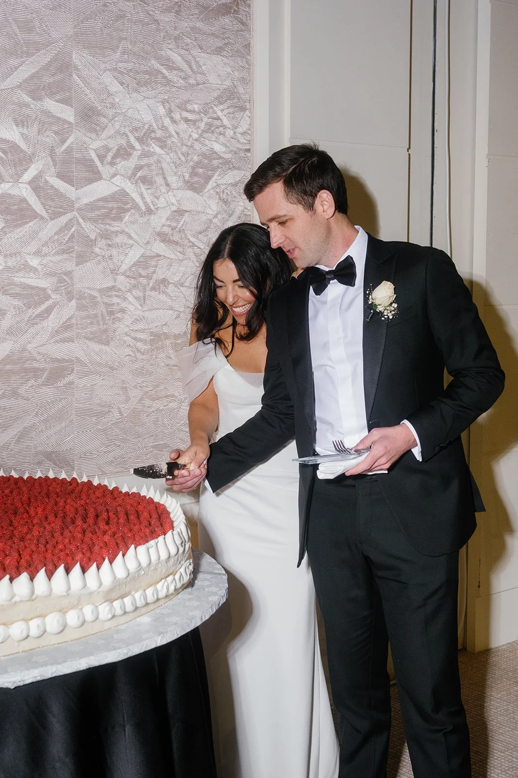 Elegant New Year’s Eve wedding at the Mandarin Oriental Boston featuring lush greenery, white florals, and red accents.