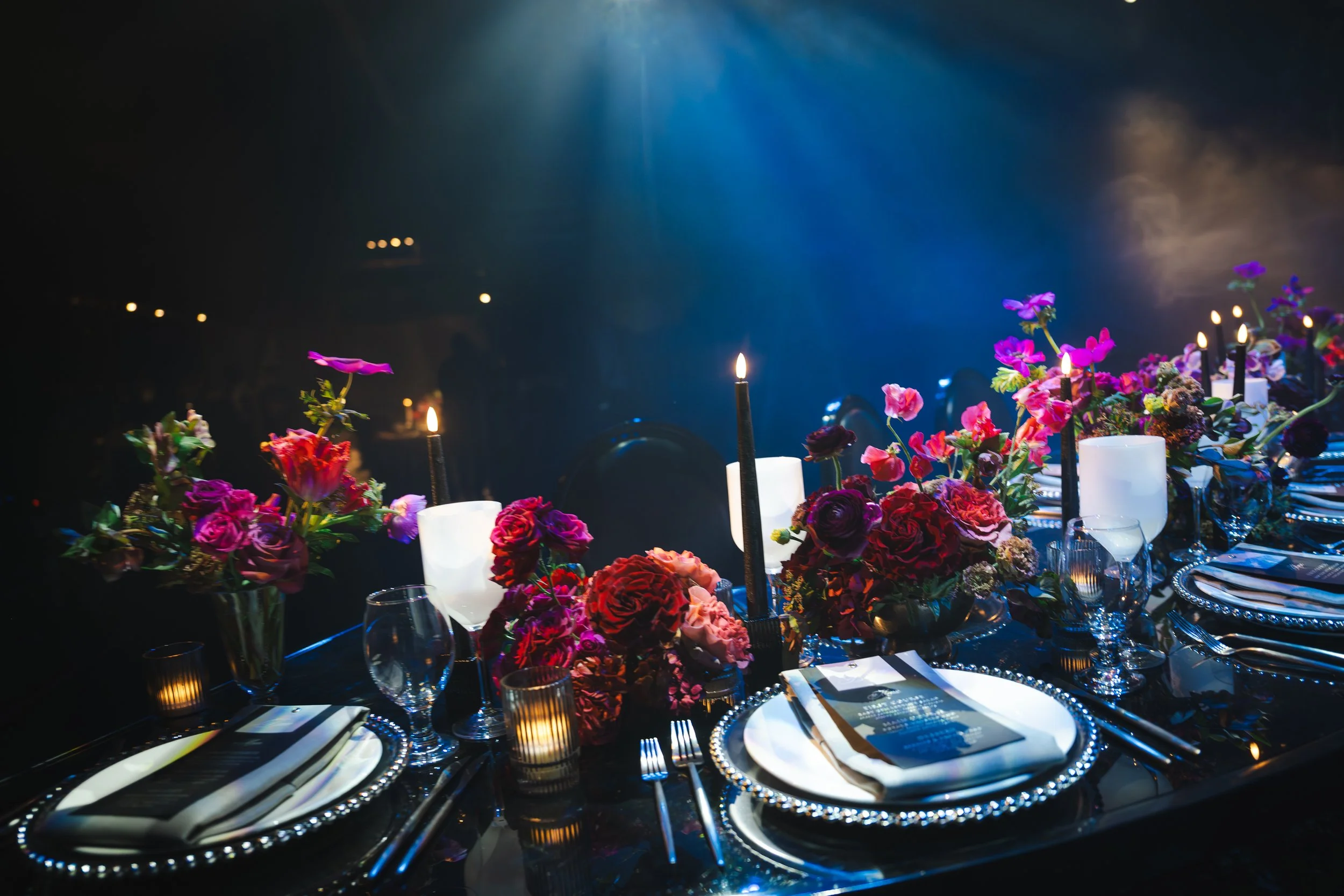 moody-wedding-reception-table-candlelight-colorful-florals.jpg