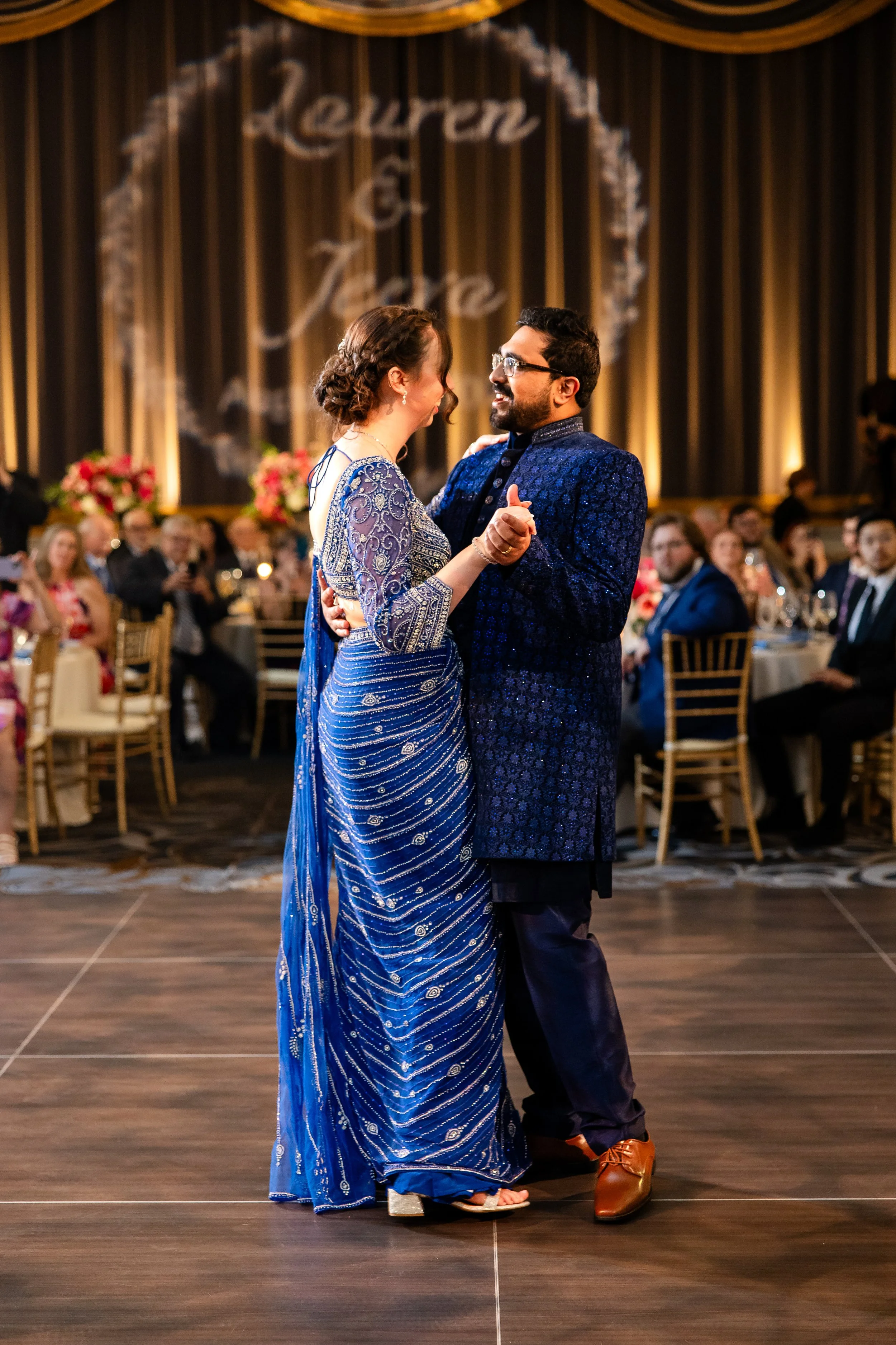 a table setting with a floral centerpiece, candles, and elegant tableware for a formal event