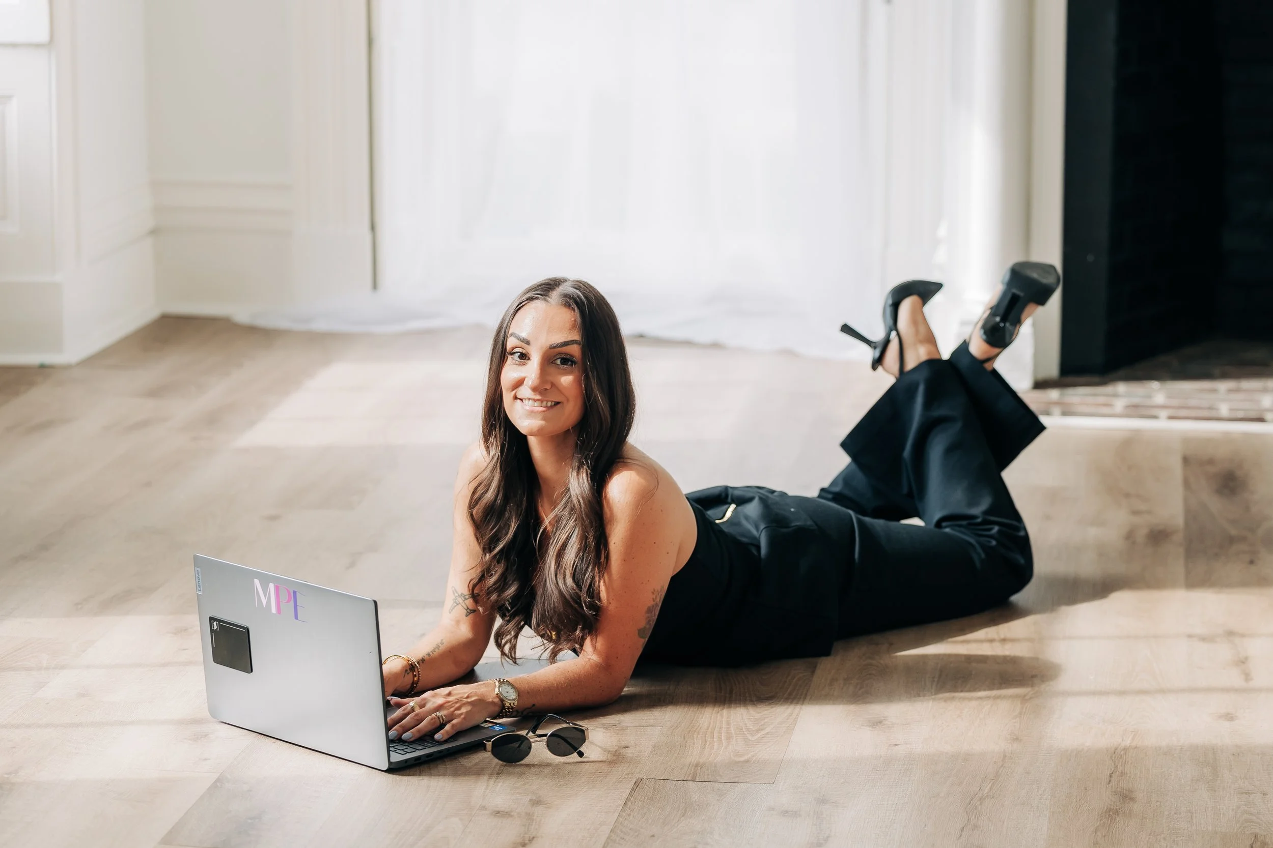 Full-service wedding planner working on a laptop while planning and managing wedding details for her clients.