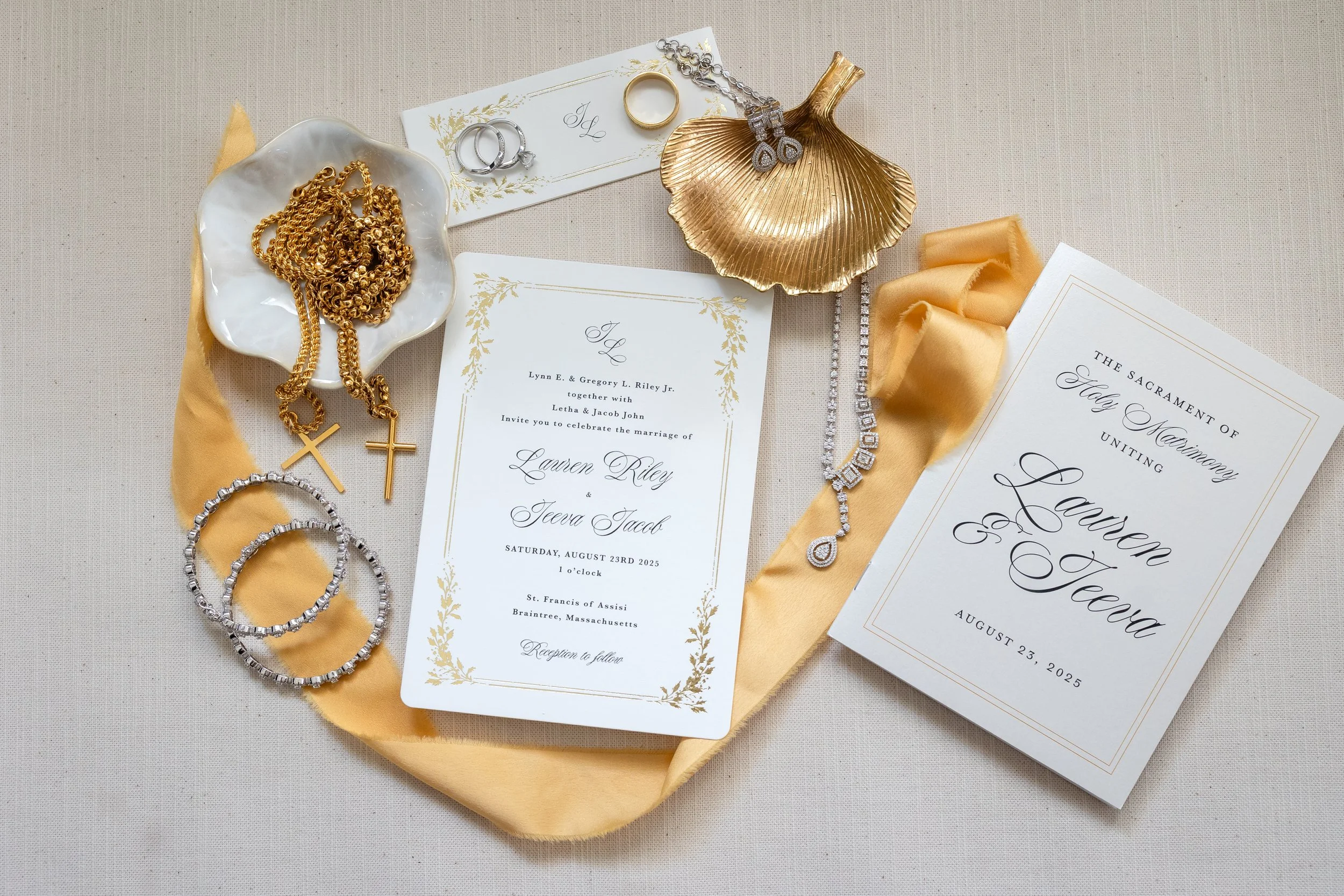 A bride and groom are dancing at their wedding reception under a large tent decorated with string lights and floral arrangements, with guests seated and watching.