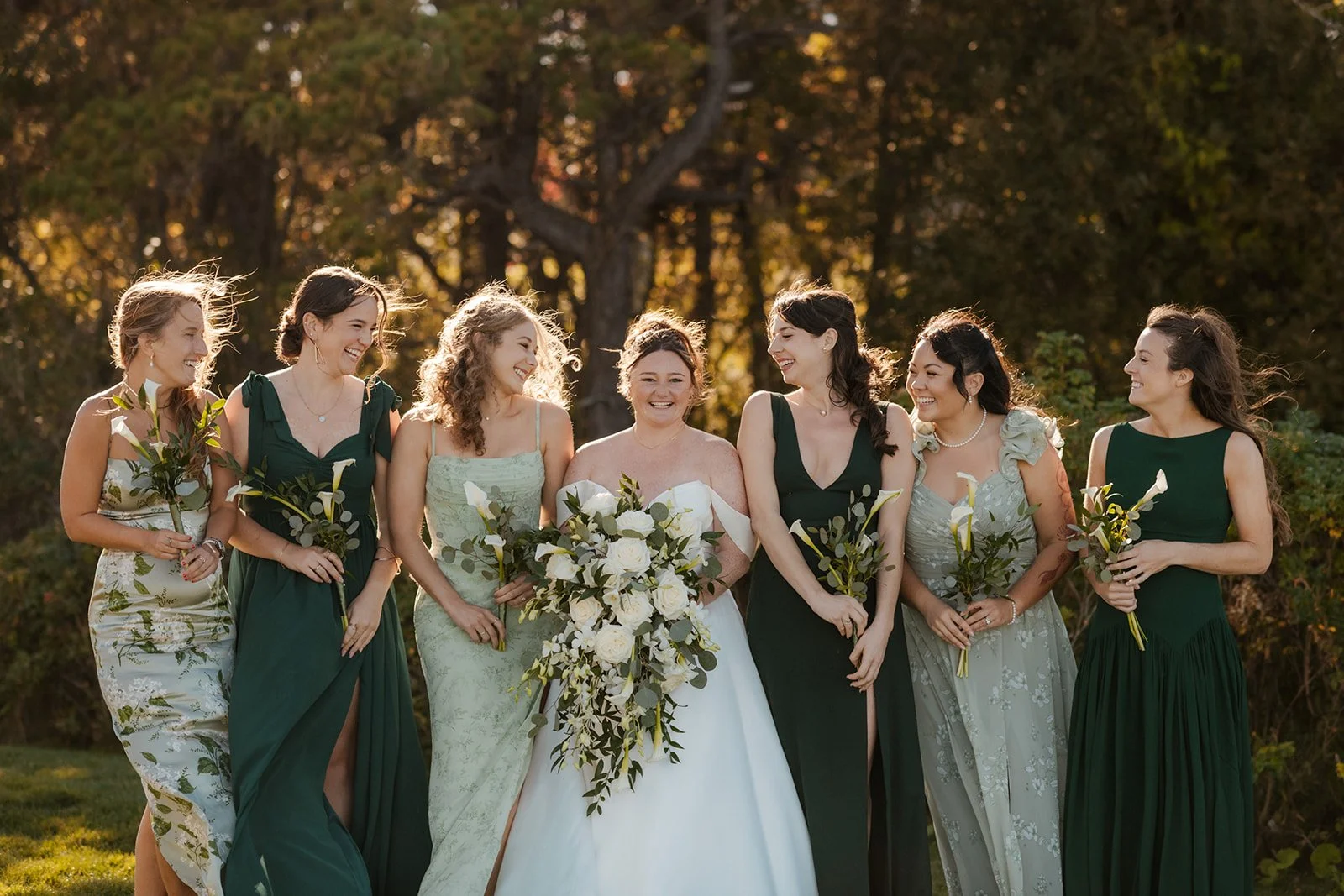 Bride with bridesmaids in green dresses at a New England coastal wedding