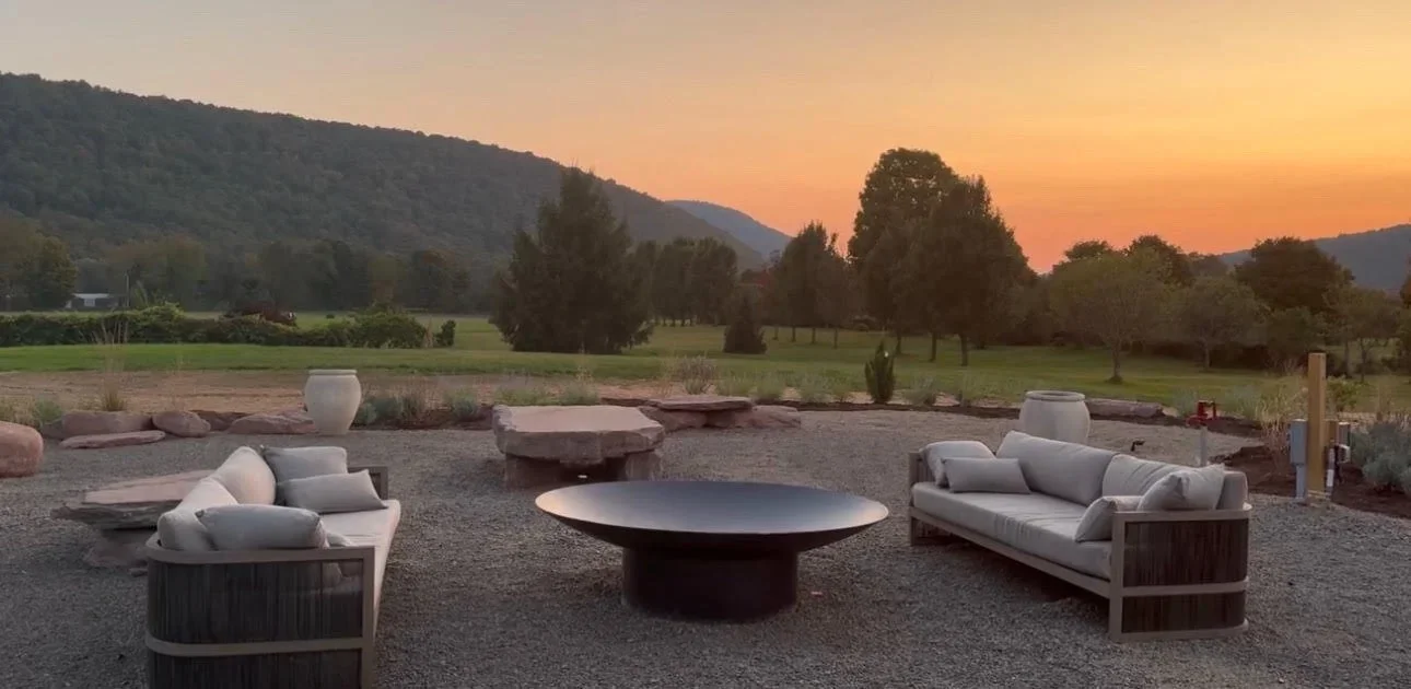 Outdoor seating and the firepit terrace at sunset, mountains beyond