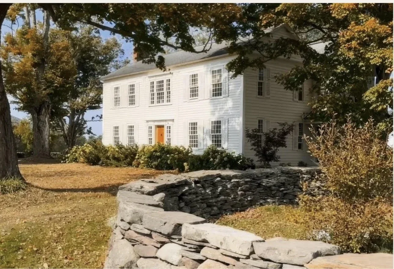 The farmhouse in autumn behind the dry stone wall