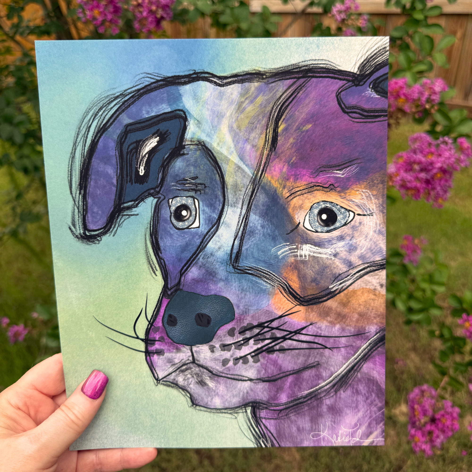 Stargazer Dog whimsical dog art print by Wild Thorn Collective photographed outdoors with purple flowers.