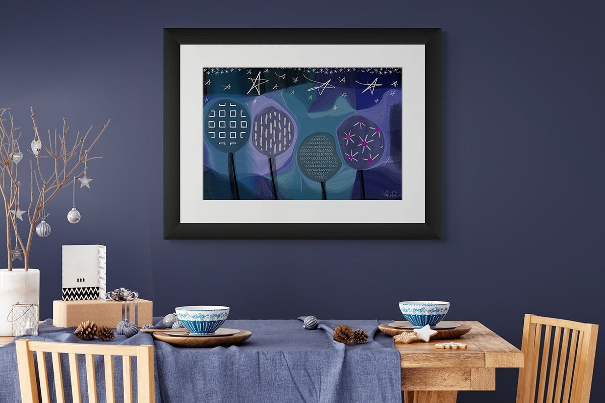 Abstract art print with whimsical trees and stars displayed in a cozy dining room with a navy wall, wood furniture, and seasonal decor.