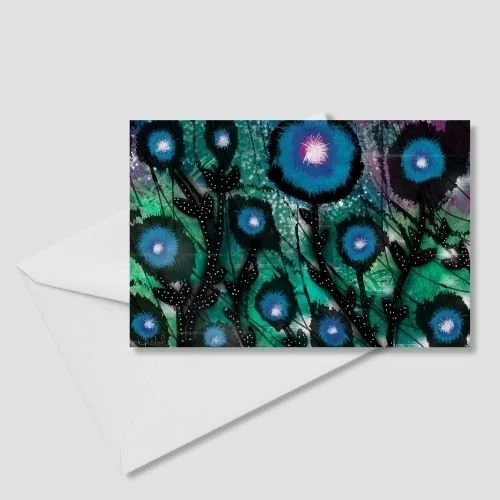 Whimsical floral greeting card with glowing blue flowers and starry centers on a teal and black cosmic background, displayed with a white envelope, by Wild Thorn Collective.