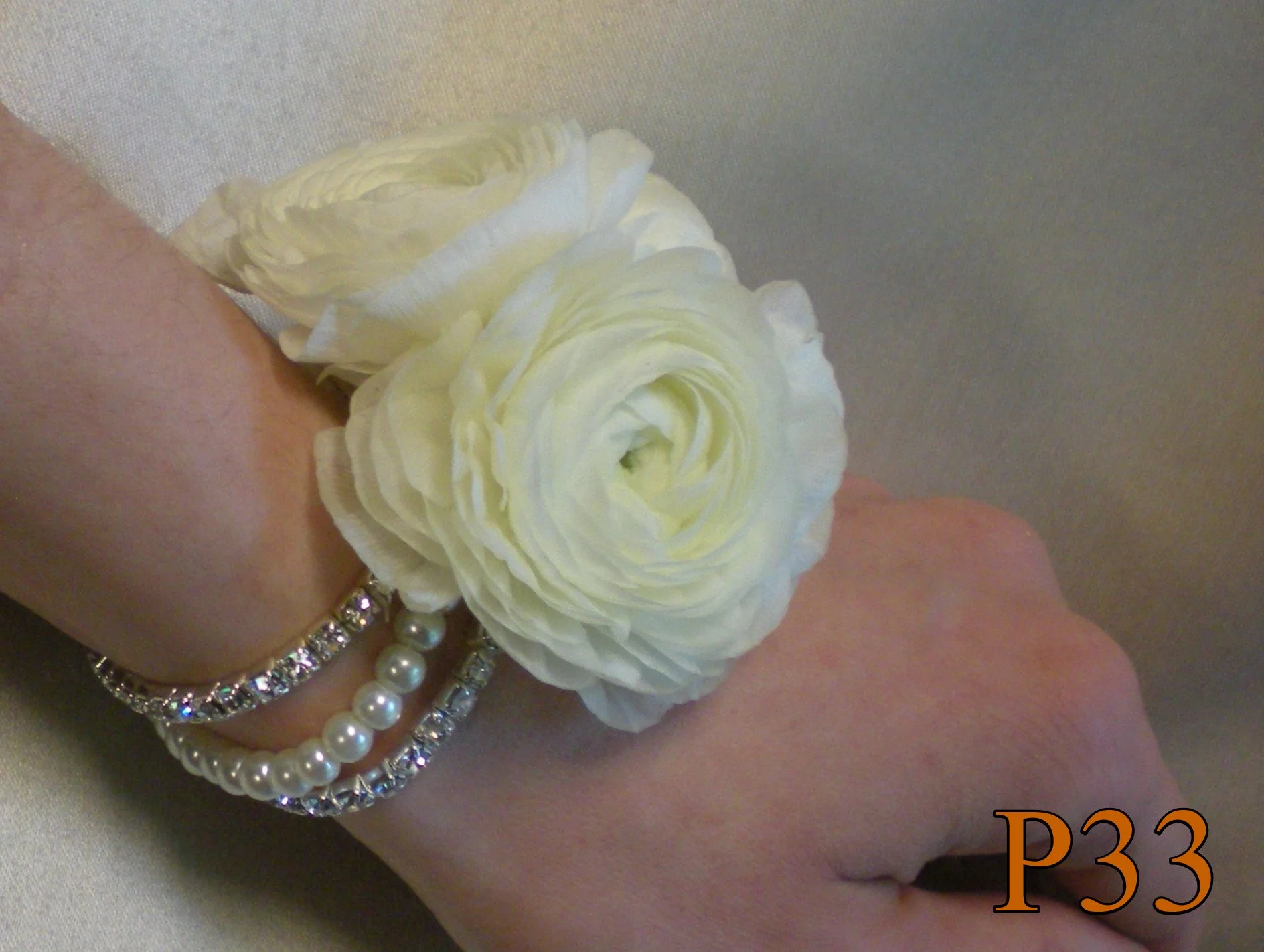 white ranunculus corsage pearl and rhinestone simple smyrna ga