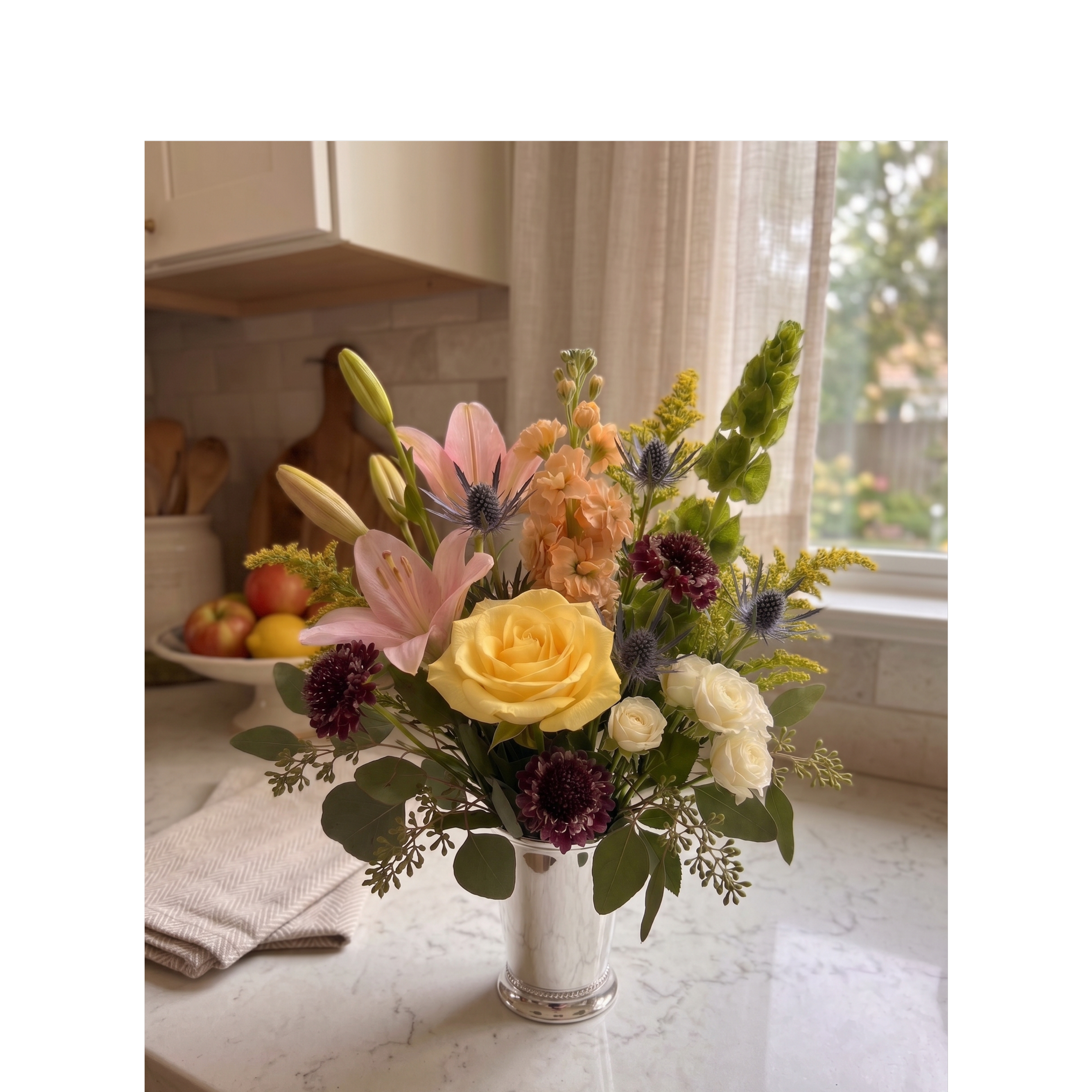 mixed colros flowers in mint julep vase.png