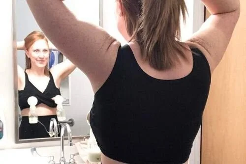 woman does hands-free pumping while getting ready