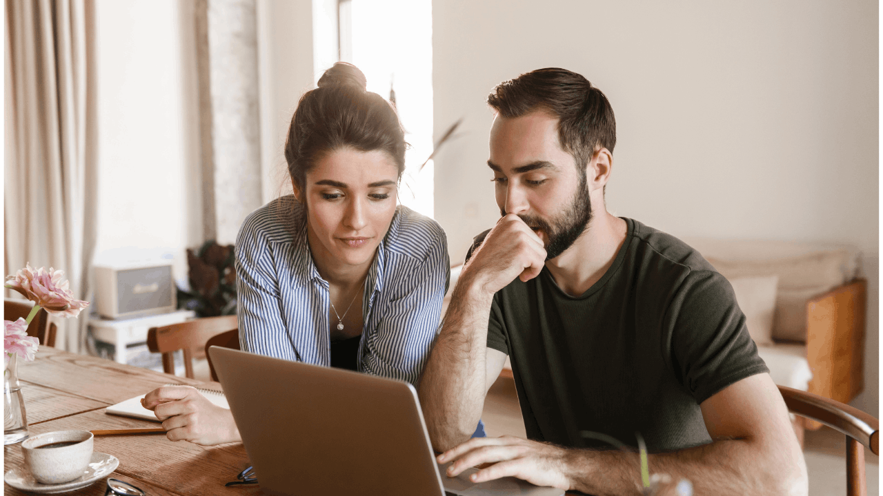 Couple discussing how to share the mental load in marriage while planning household responsibilities at the kitchen table