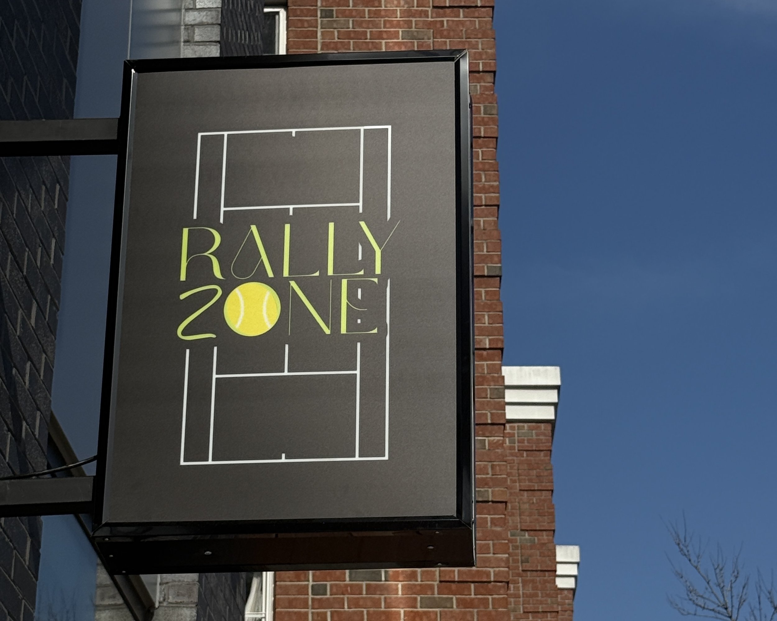 Rally Zone Jersey City indoor tennis court with AI-powered ball machines lined up