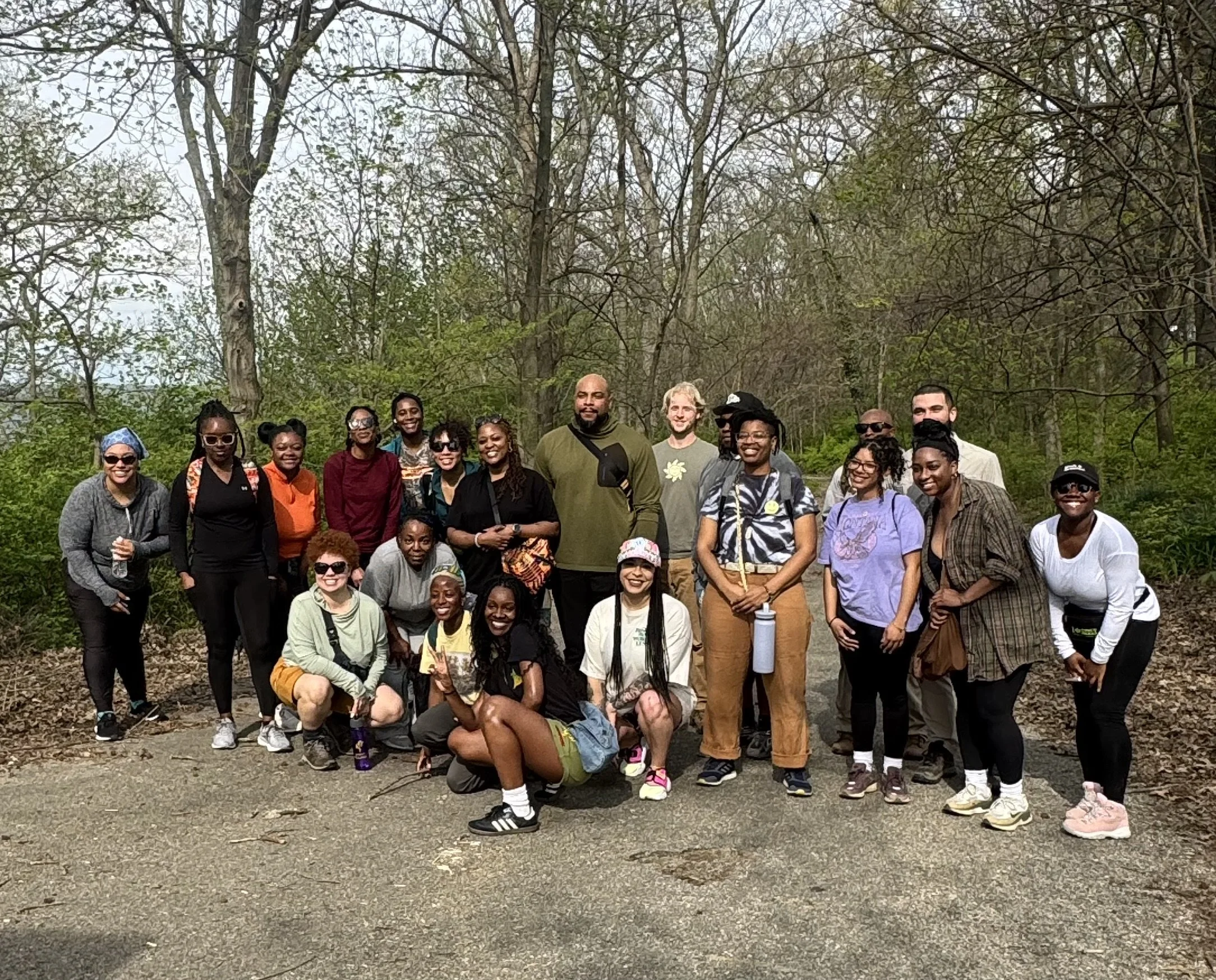 Group of Hikers from a We Outside hike smiling at camera at the trailhead