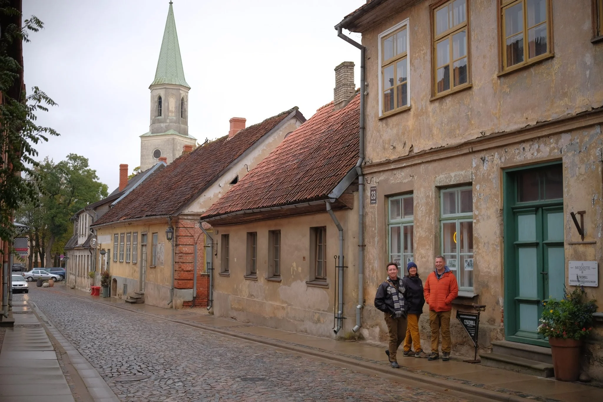 Vincent, Elaine, and Matt Pruis in Kuldīga with St. Catherine’s in the background, 2025.