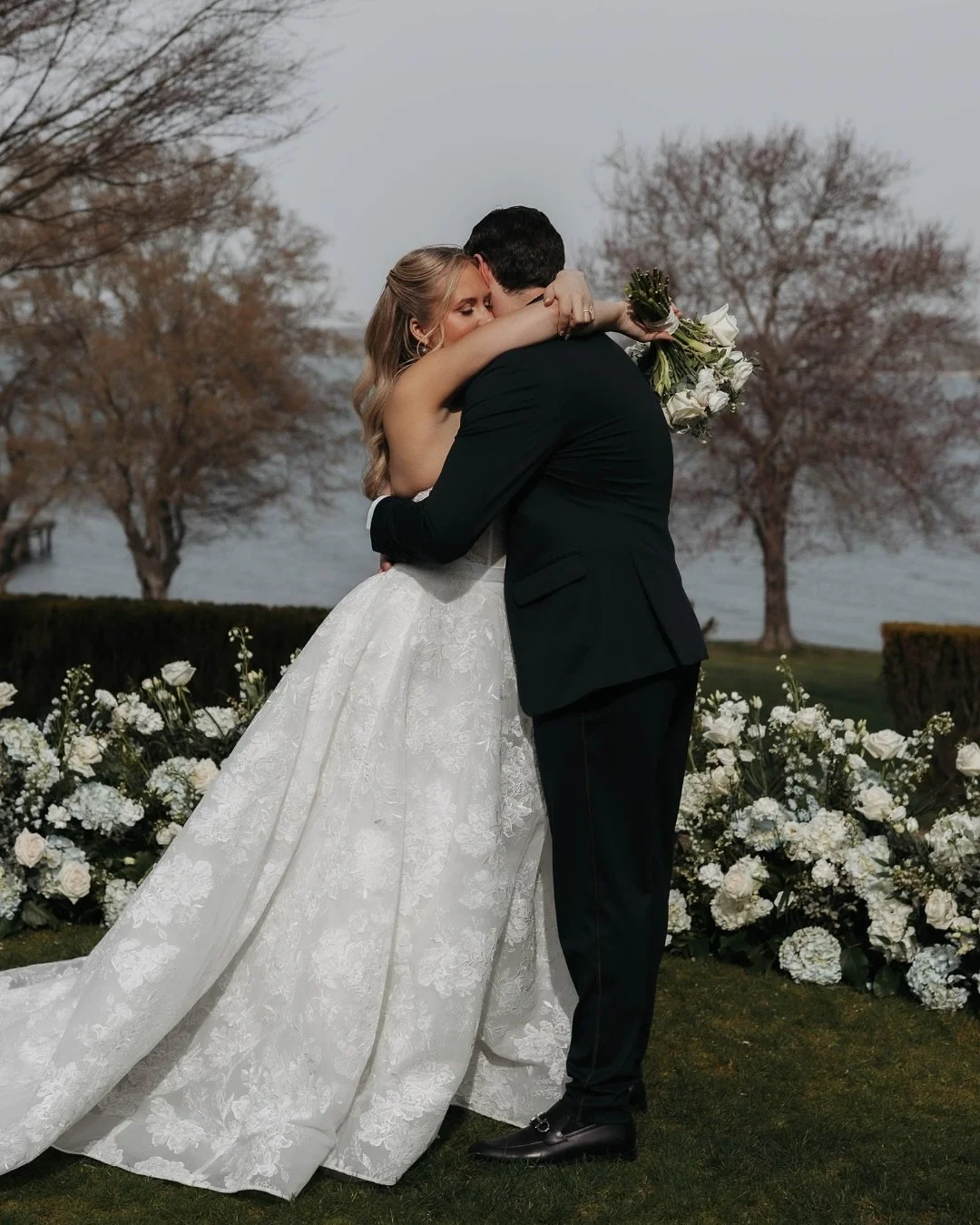 A ceremony framed by the sea, a mansion steeped in history, and florals that felt alive within it all. 

At Glen Manor House, we designed a half-moon of crisp white and blue blooms to embrace the couple at ground level &mdash; allowing the sweeping o