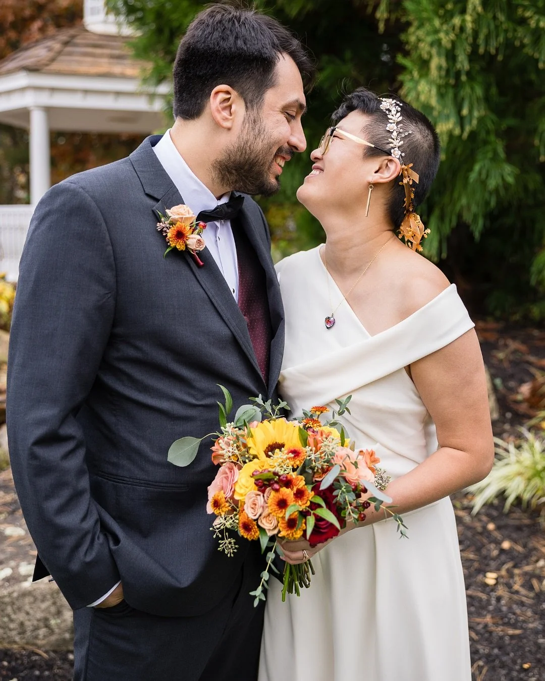 You had us at sunflowers 🌻

This bouquet blends lush roses, rust-toned mums, and speckled blossoms&mdash;with each bloom chosen for warmth, joy, and meaning. The single sunflower at its heart was placed in memory of the bride&rsquo;s mother, a quiet