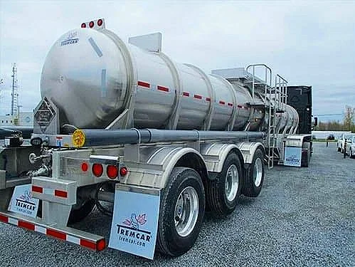 Stainless steel tanker trailer with three axles.