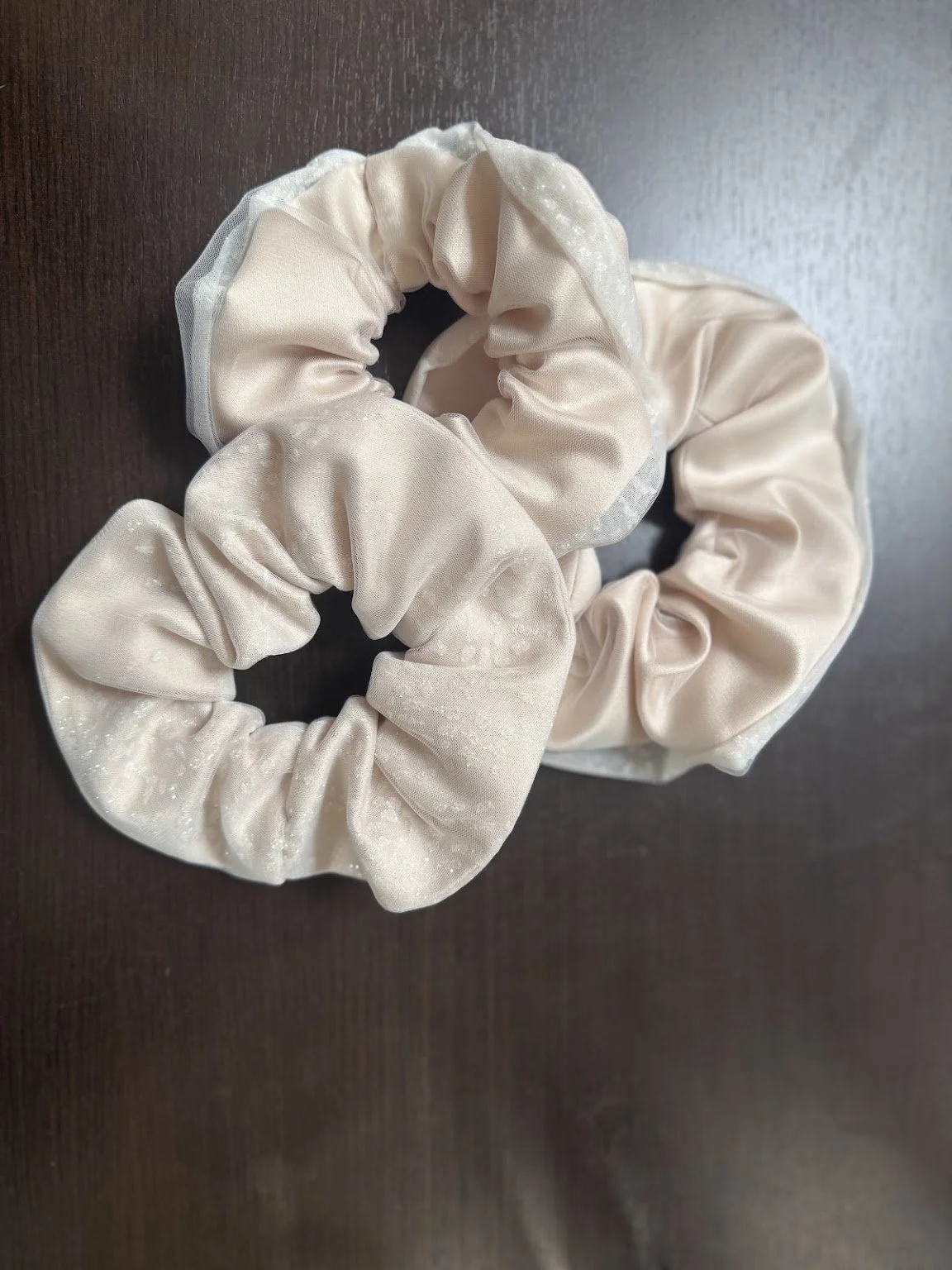 A set of our Custom Memorabilia Scrunchies made from the hem of our bride's gown.