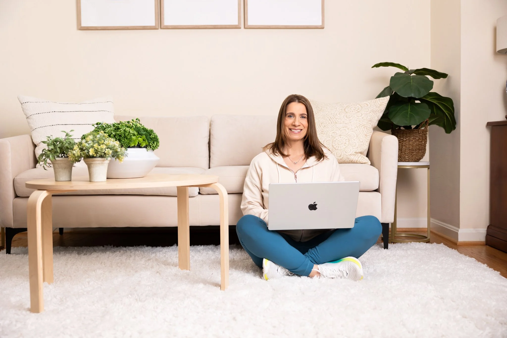 Woman reviewing a pre-surgery checklist on the floor in front of her couch before knee replacement surgery